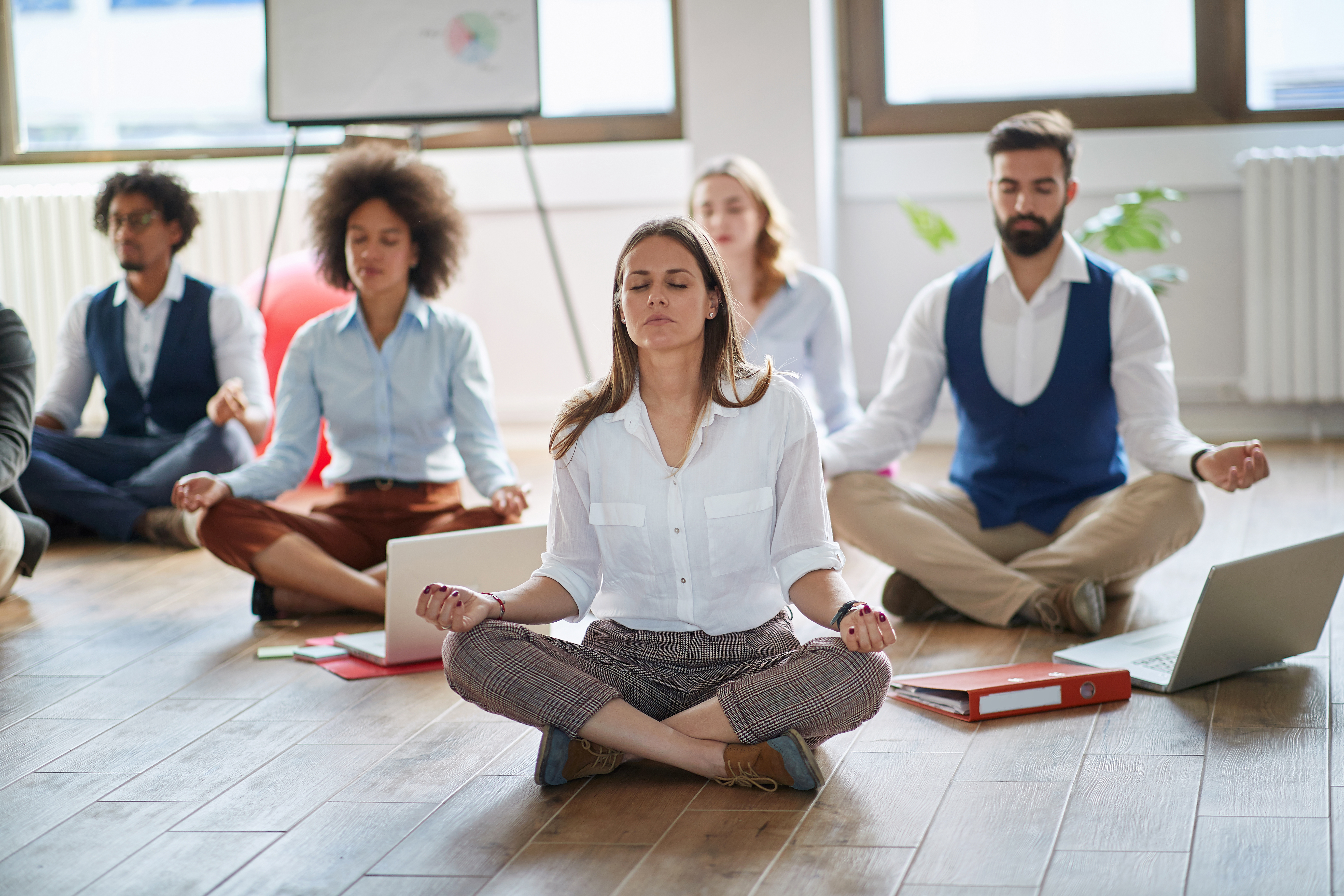 businesswoman meditating at work group of business 0e7f5fb06c188aa4ceff