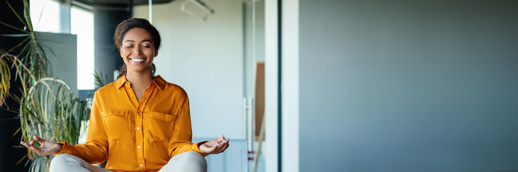 calm black businesswoman meditating with closed ey e4a391a645e454c70e00