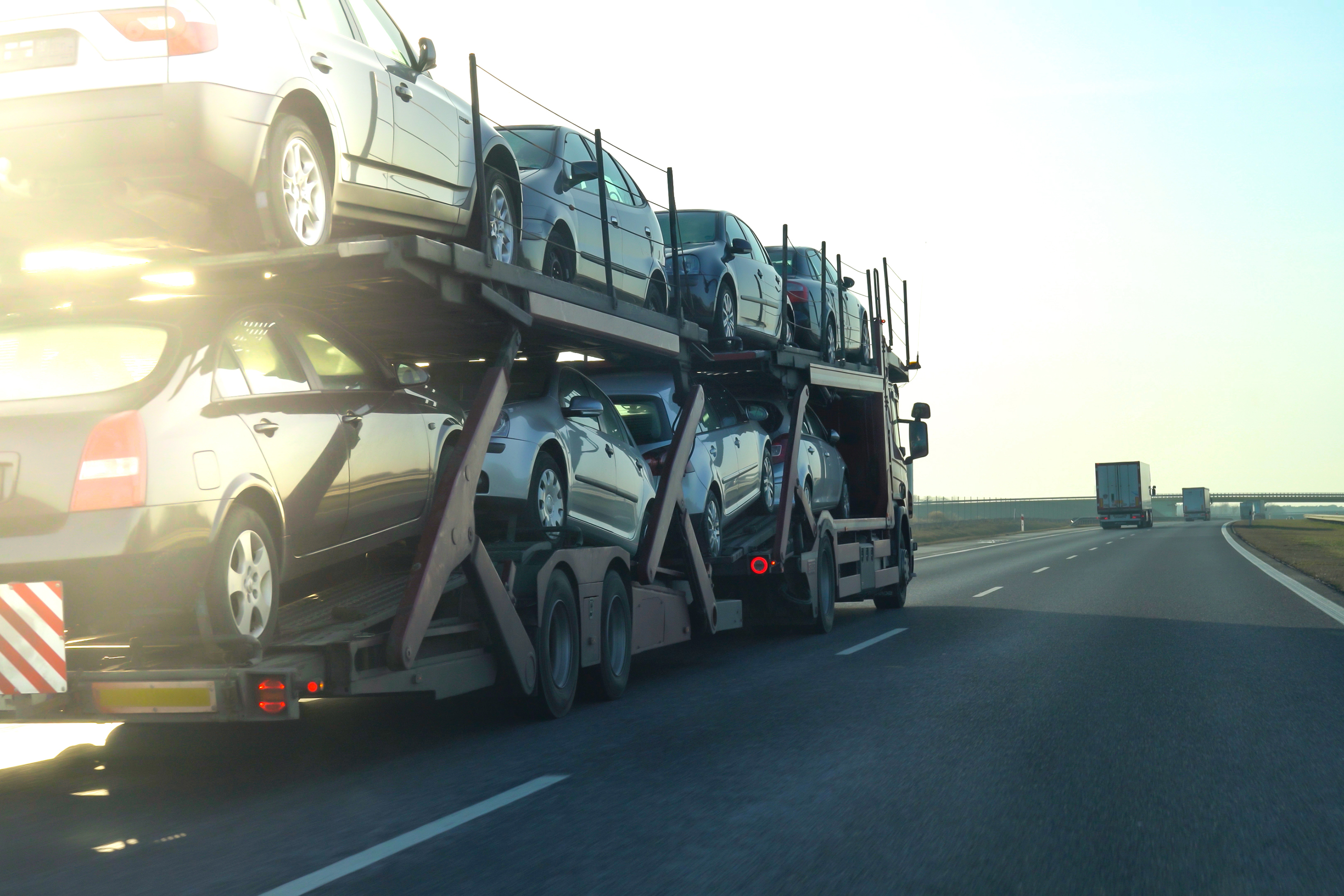 car transporter trailer loaded with many cars on a 9c5390cf6b55e3a5a2e6