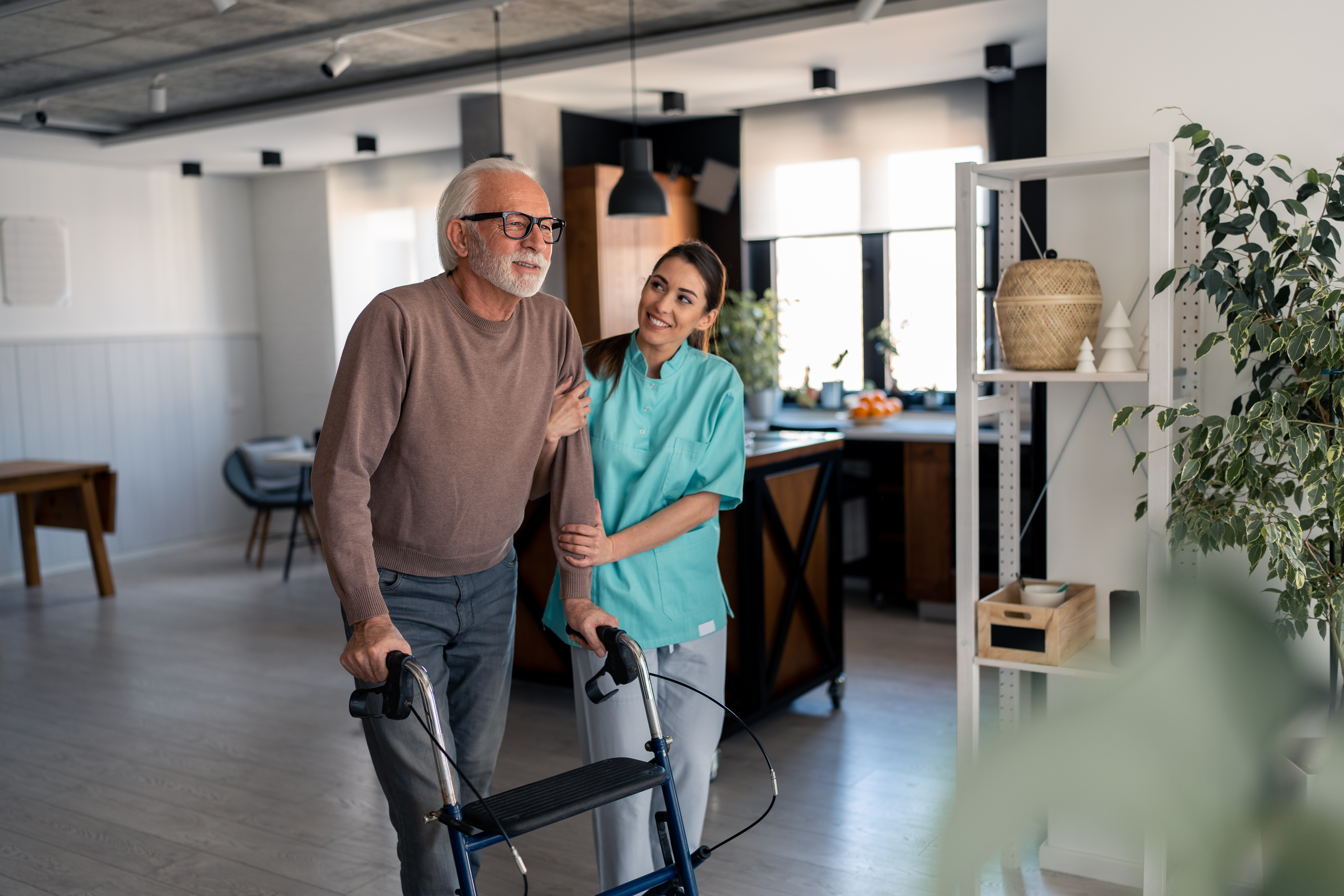 caring nurse assisting elderly male patient to wal 548eb10e54534d126d2b