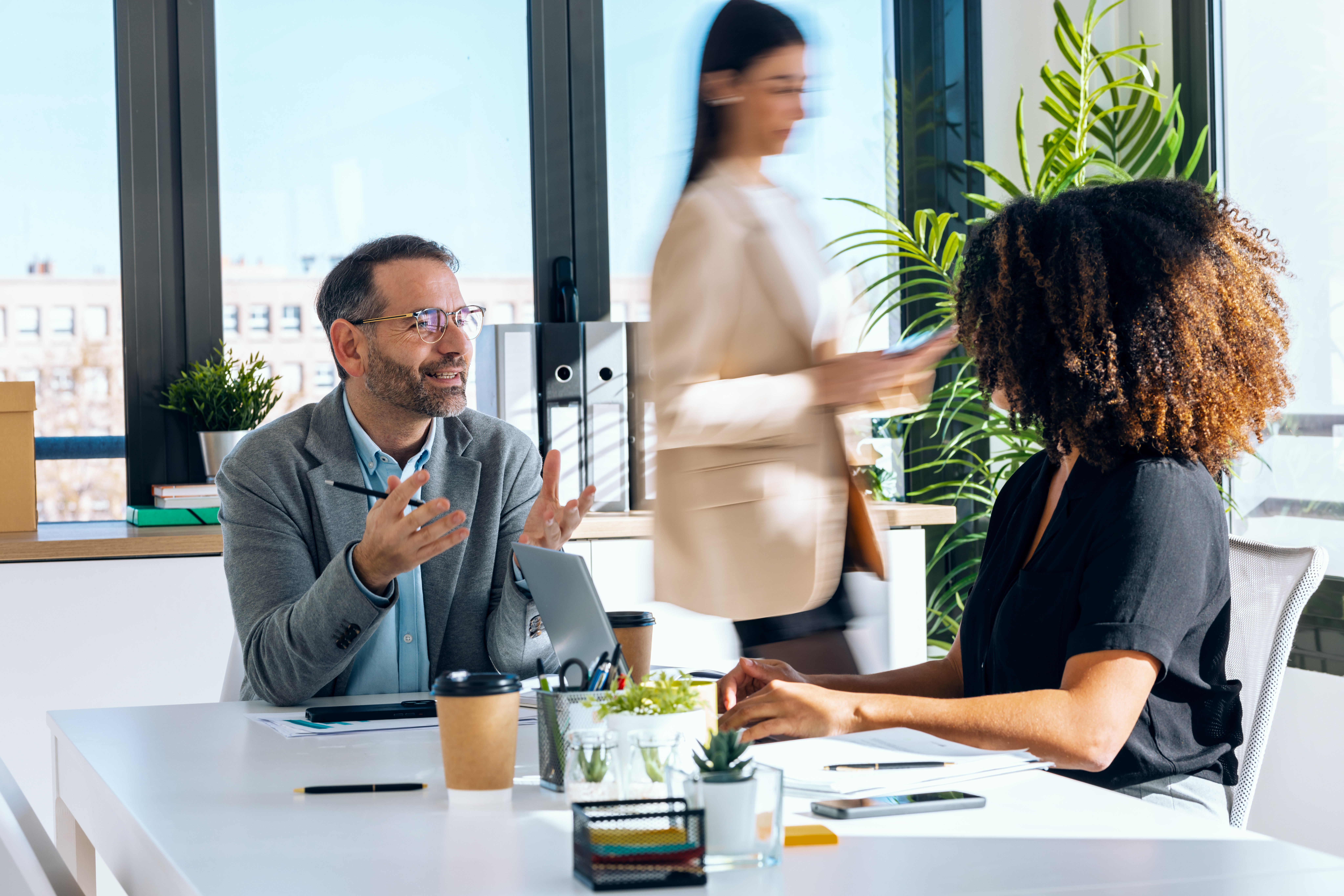 Diverse group of professionals collaborating in a modern SME workplace – Human-First HR in action