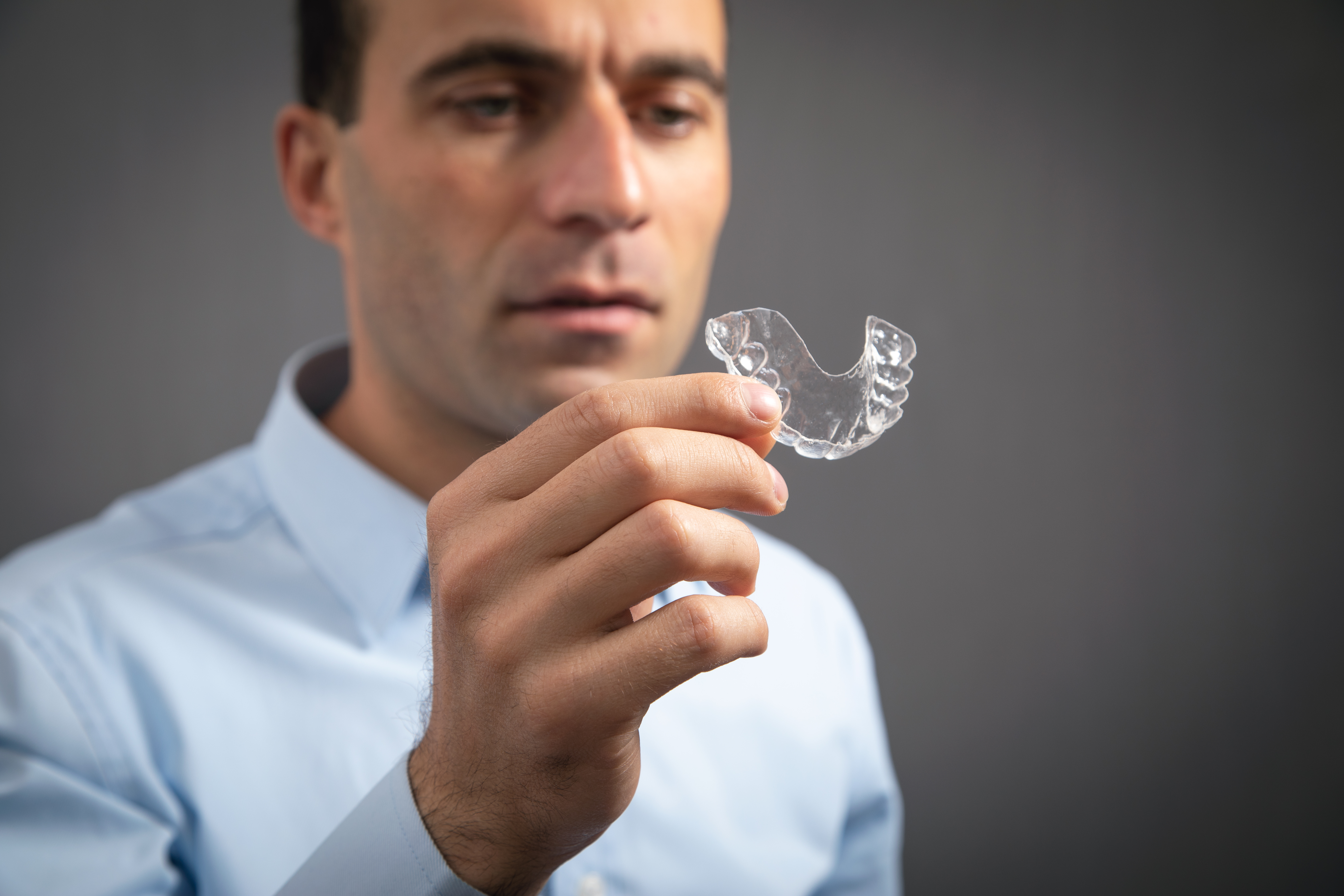 Why Custom Plastic Fabrication Is Essential for Durable, Reliable Results 1 caucasian man showing transparent aligner eab46a022896612fb132