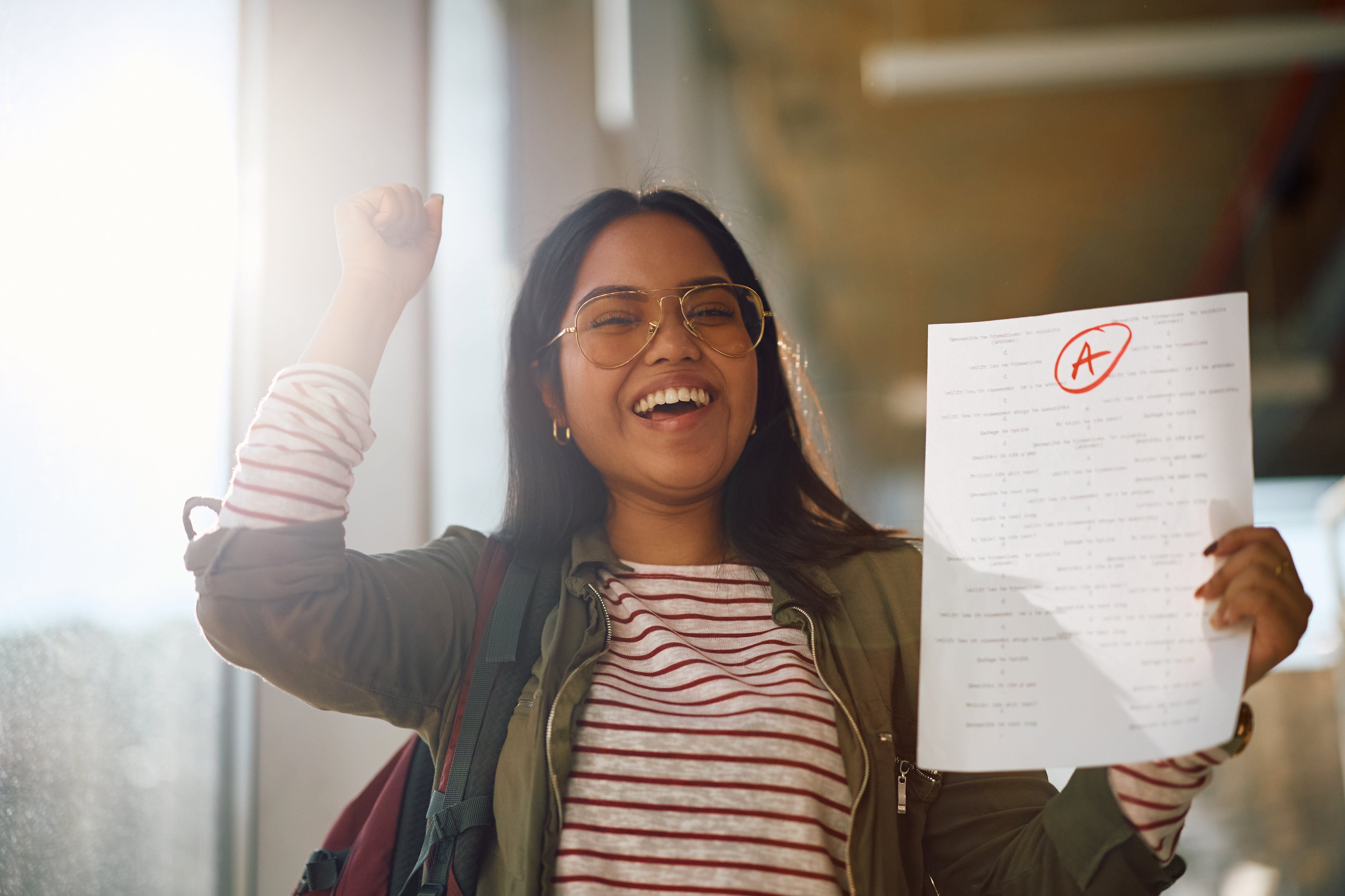 woman cheering her exam results - illustrative image to describe OET By Accordemy® refund guarantee policy