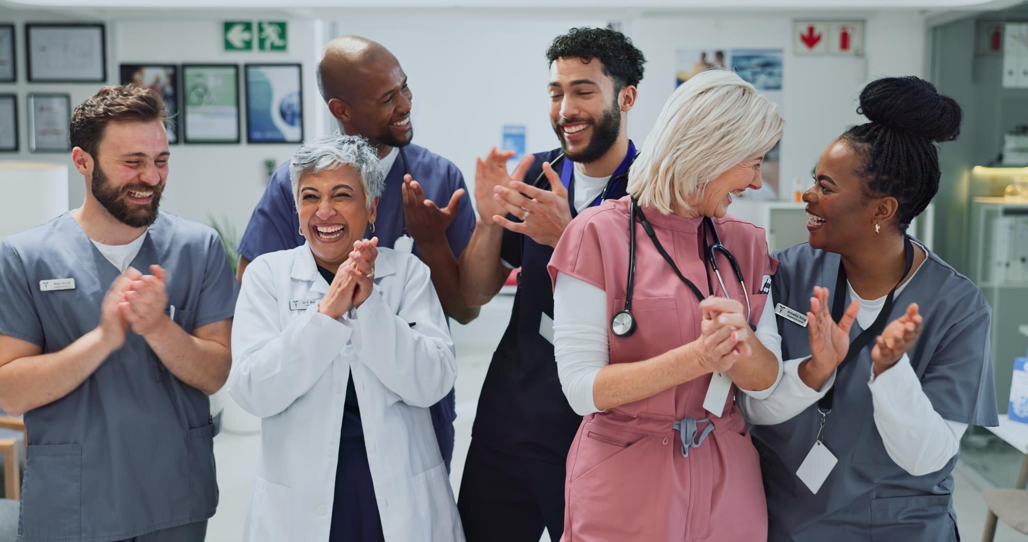 clapping smile and doctors in hospital celebration b8777c116c8b90234bc1