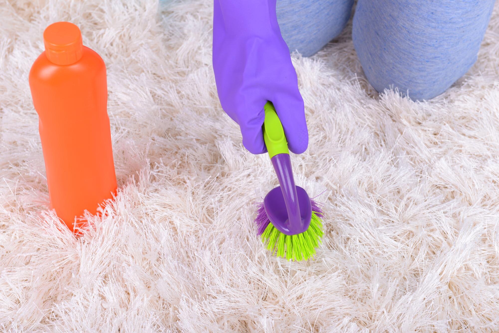 Carpet Care 101: Essential Dos and Don'ts for Spot Cleaning 9 cleaning carpet with brush close up 99f6f8d8d097e6cfdb5f