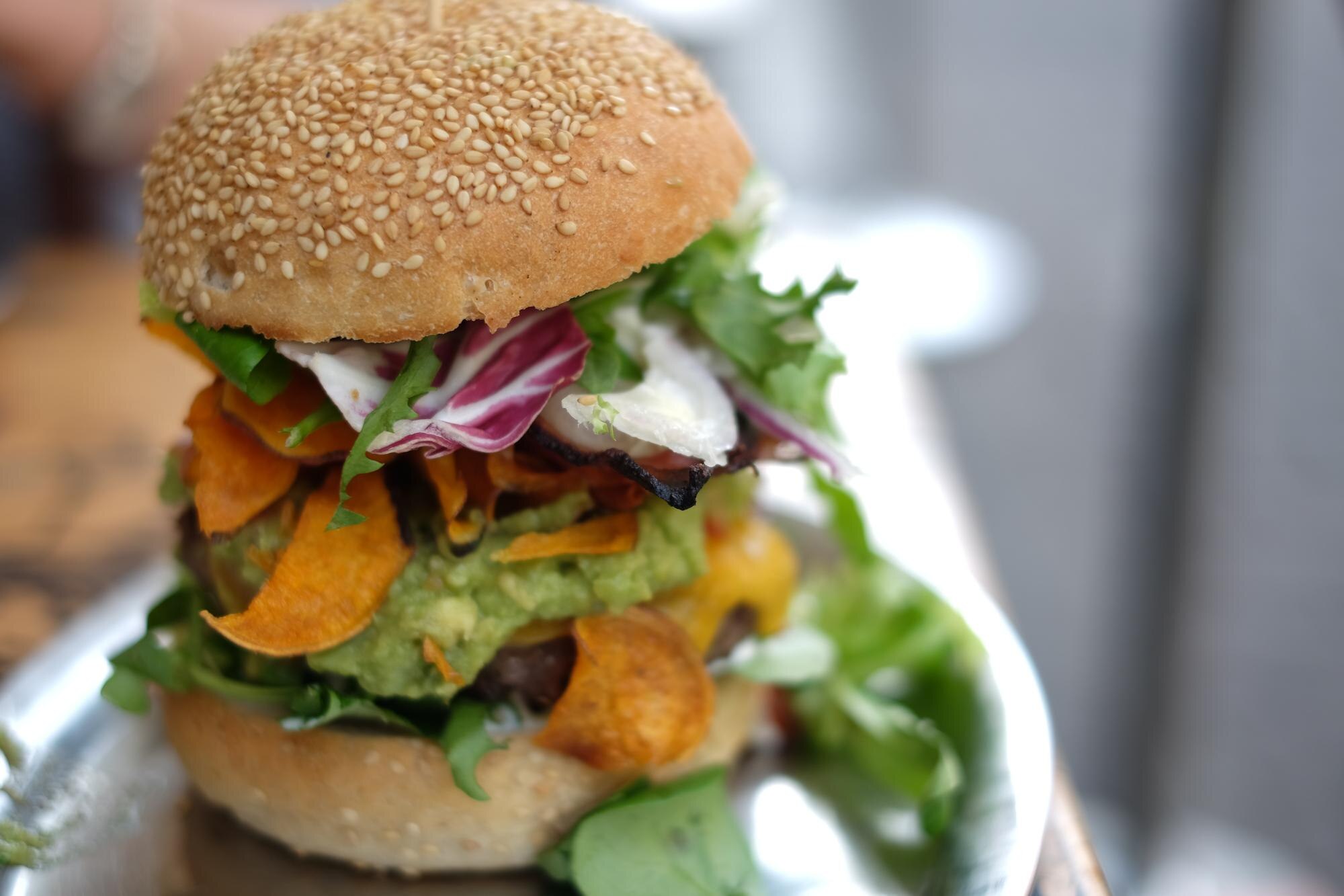 close up of burger in plate on table 13b70893aff5aaff026f