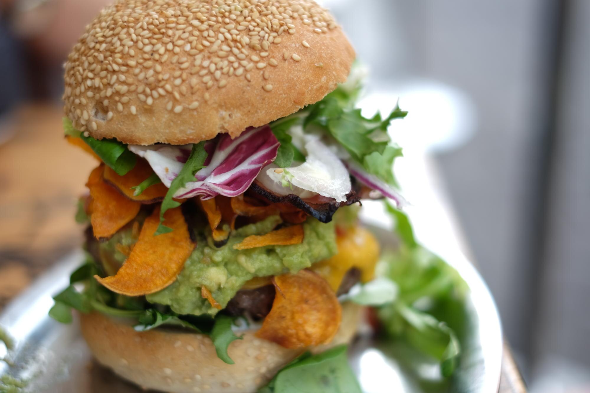 close up of burger in plate on table 7a6c85d860e8063f2045