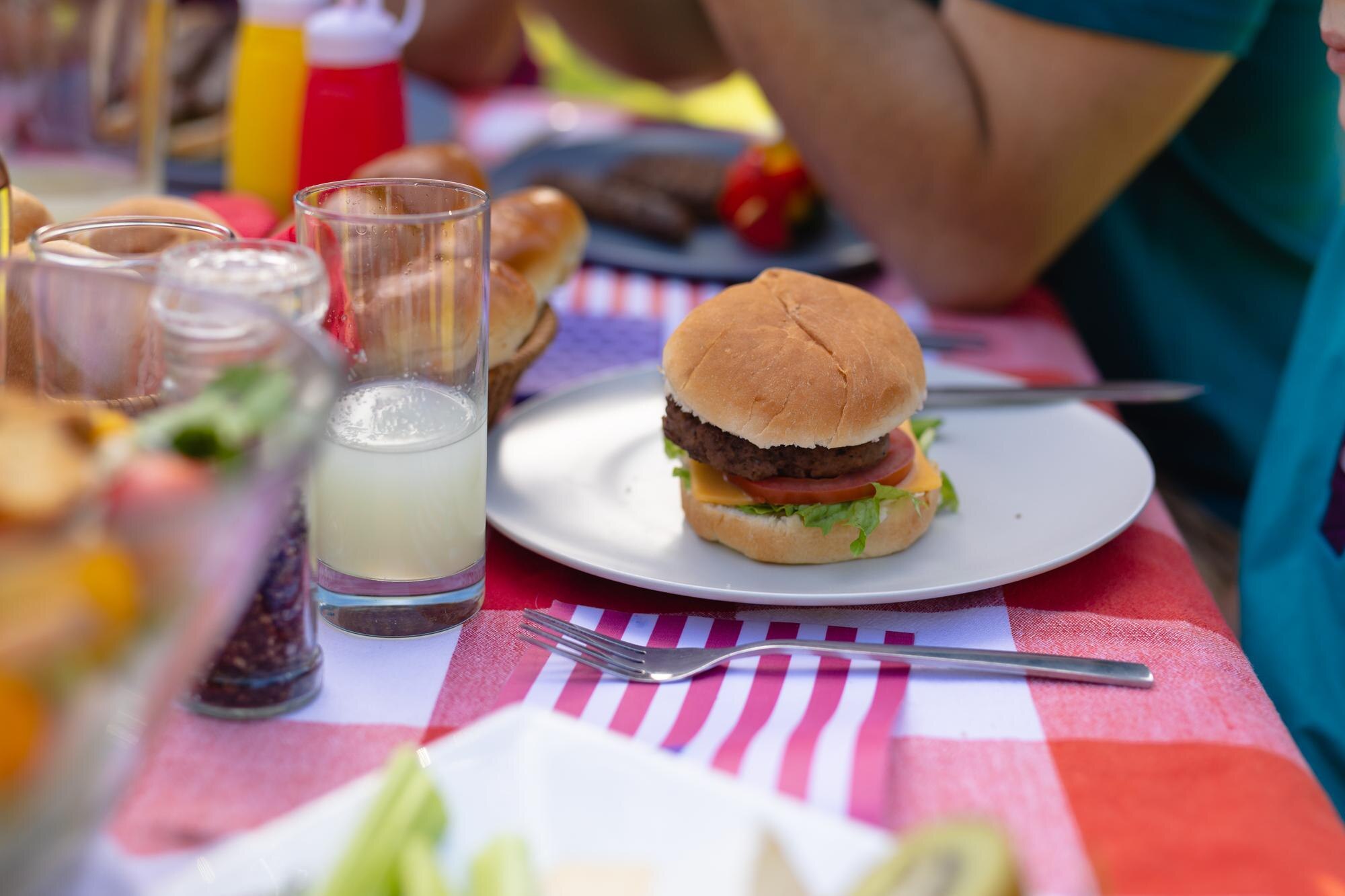 Fast, Fresh, and Family‑Approved: Why Jubilee Juice & Grill Brings Everyone to the Table 1 close up of burger served in plate by drinks on ta 37be5eaf95a22f415f2f