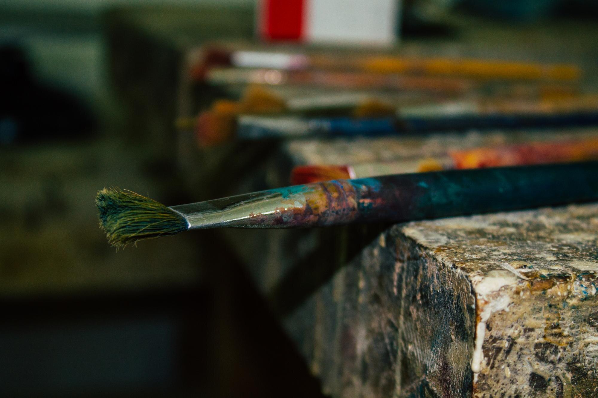 close up of paintbrushes on rusty metal cfa1347565ec5136cb7e