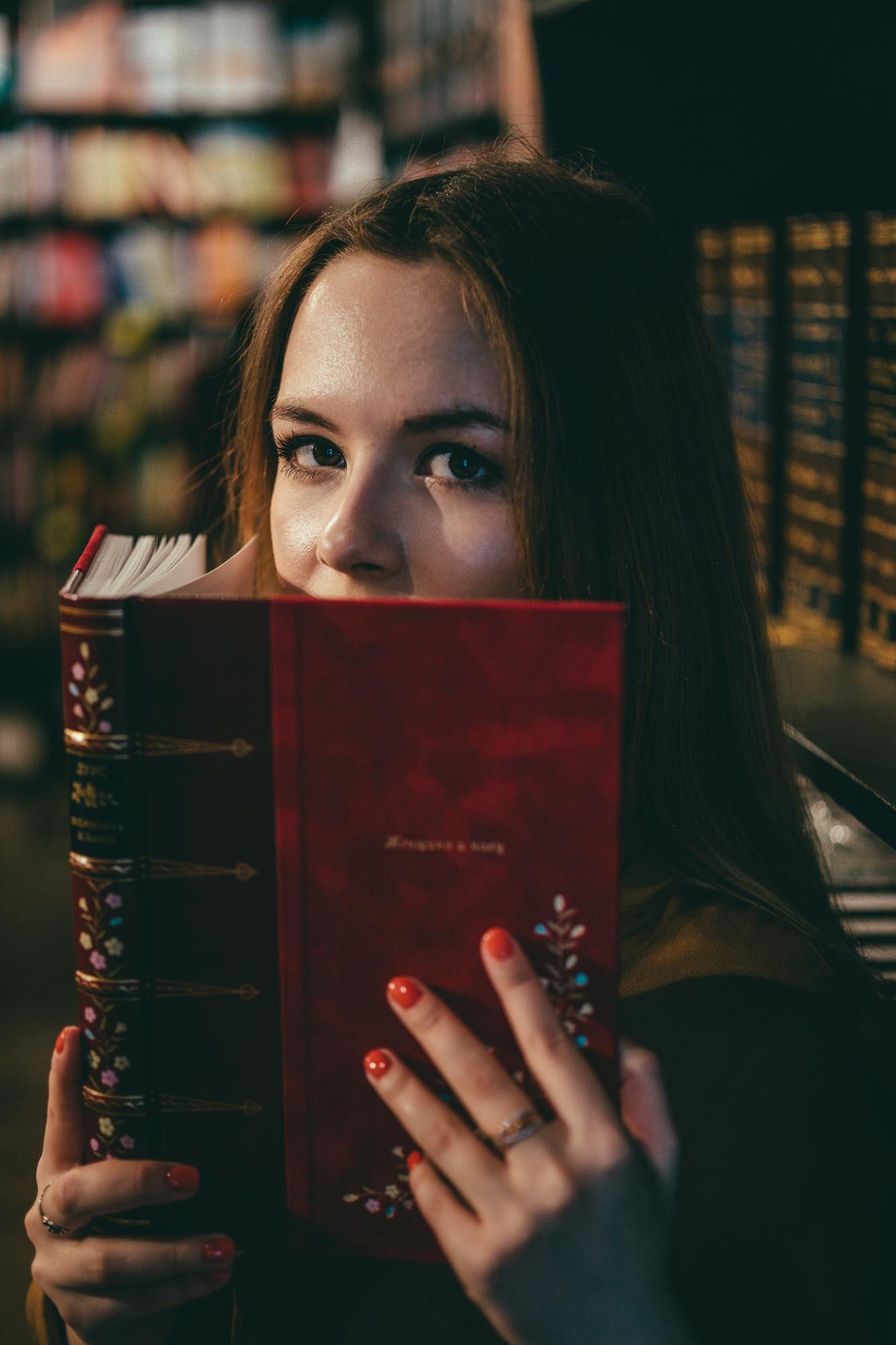 close up portrait of young woman reading book in l 9eebe888a5ecb4aab6f2