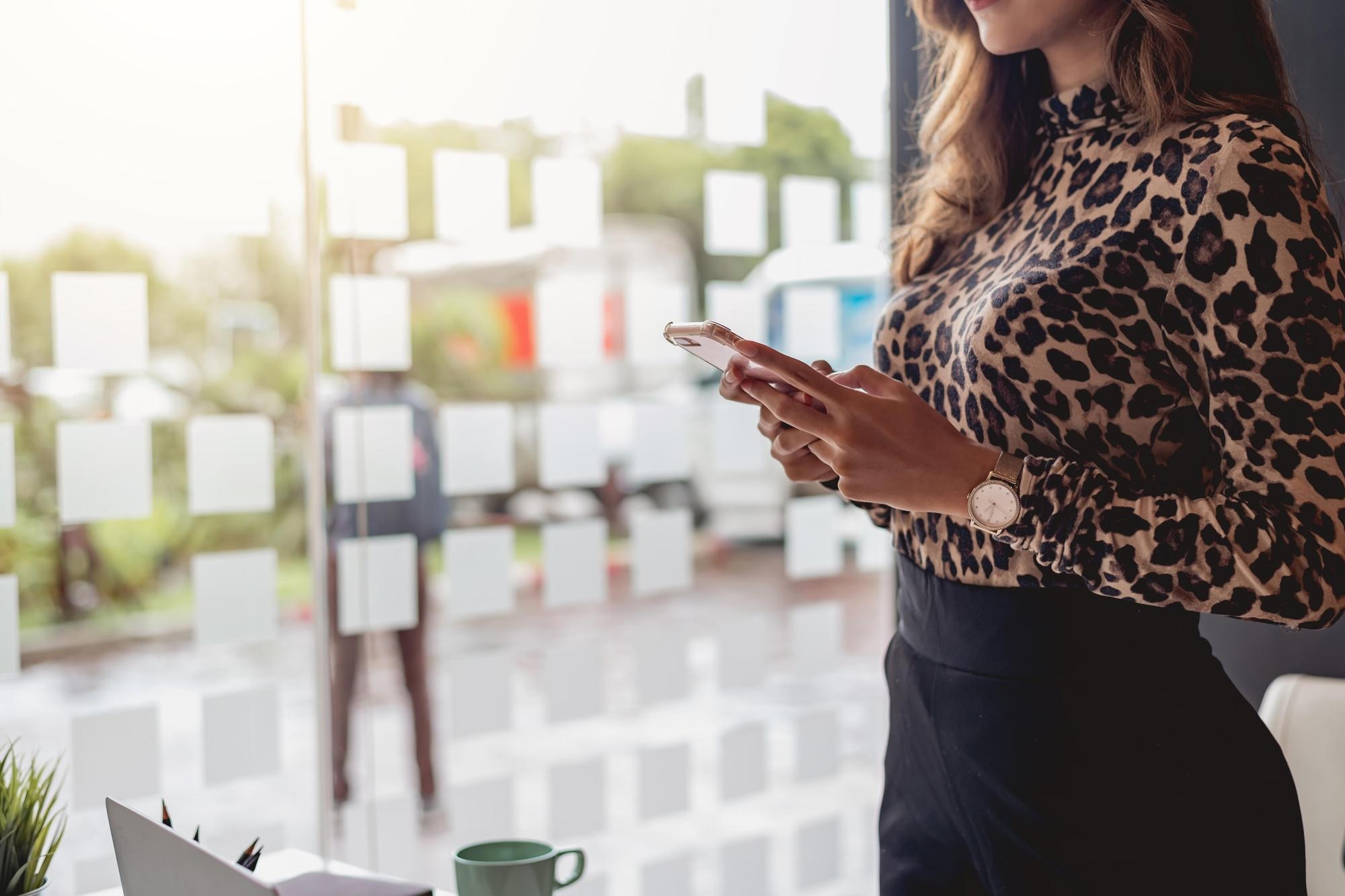 close up hand businesswoman standing using app on c6d0bf35ae8e21eadd66