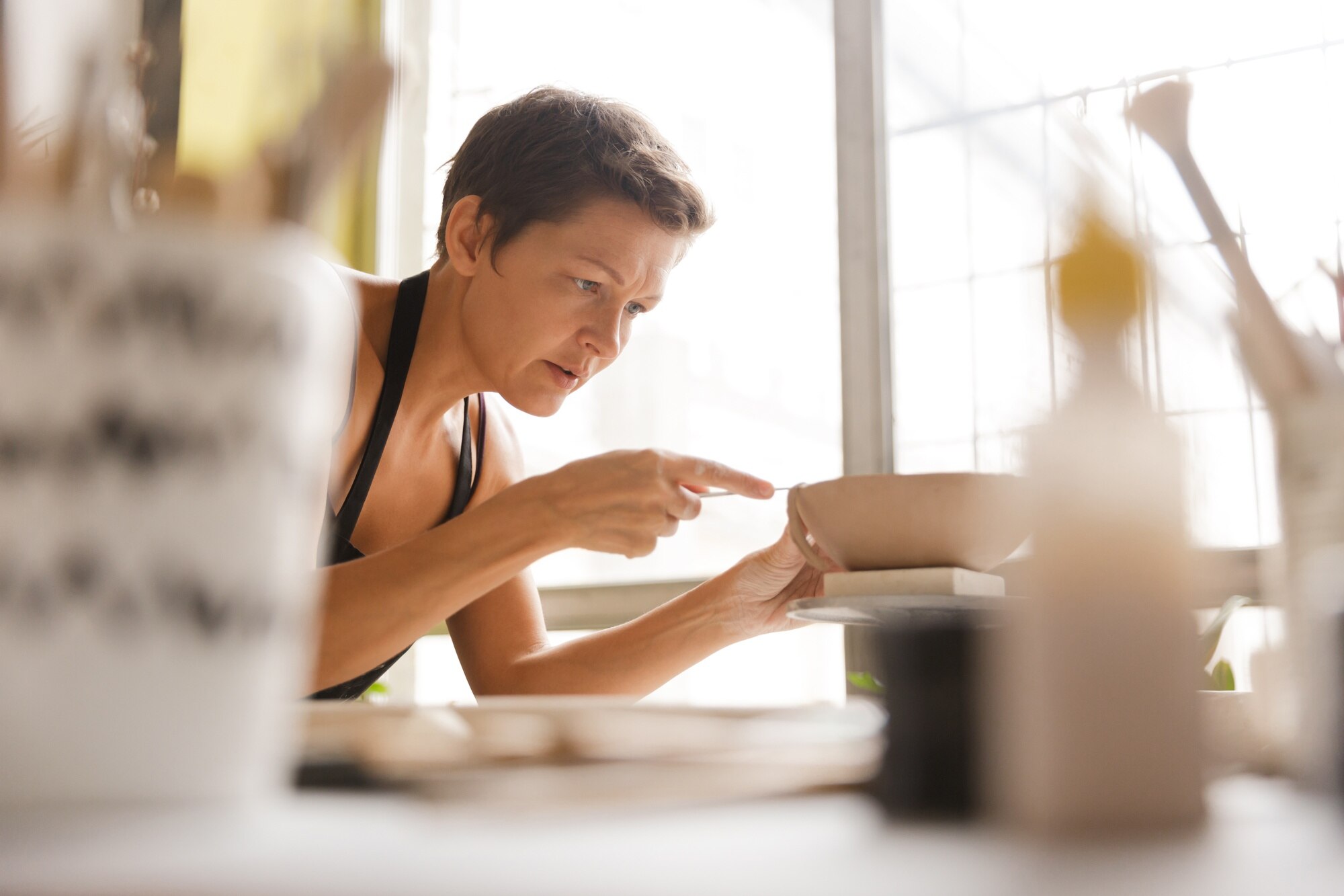 Bulk Custom Plastic Fabrication: Essential Tips to Order Right (and Avoid Hold-ups) 1 close up of a woman making ceramic and pottery tab 40ccadc2c974b3850fb5