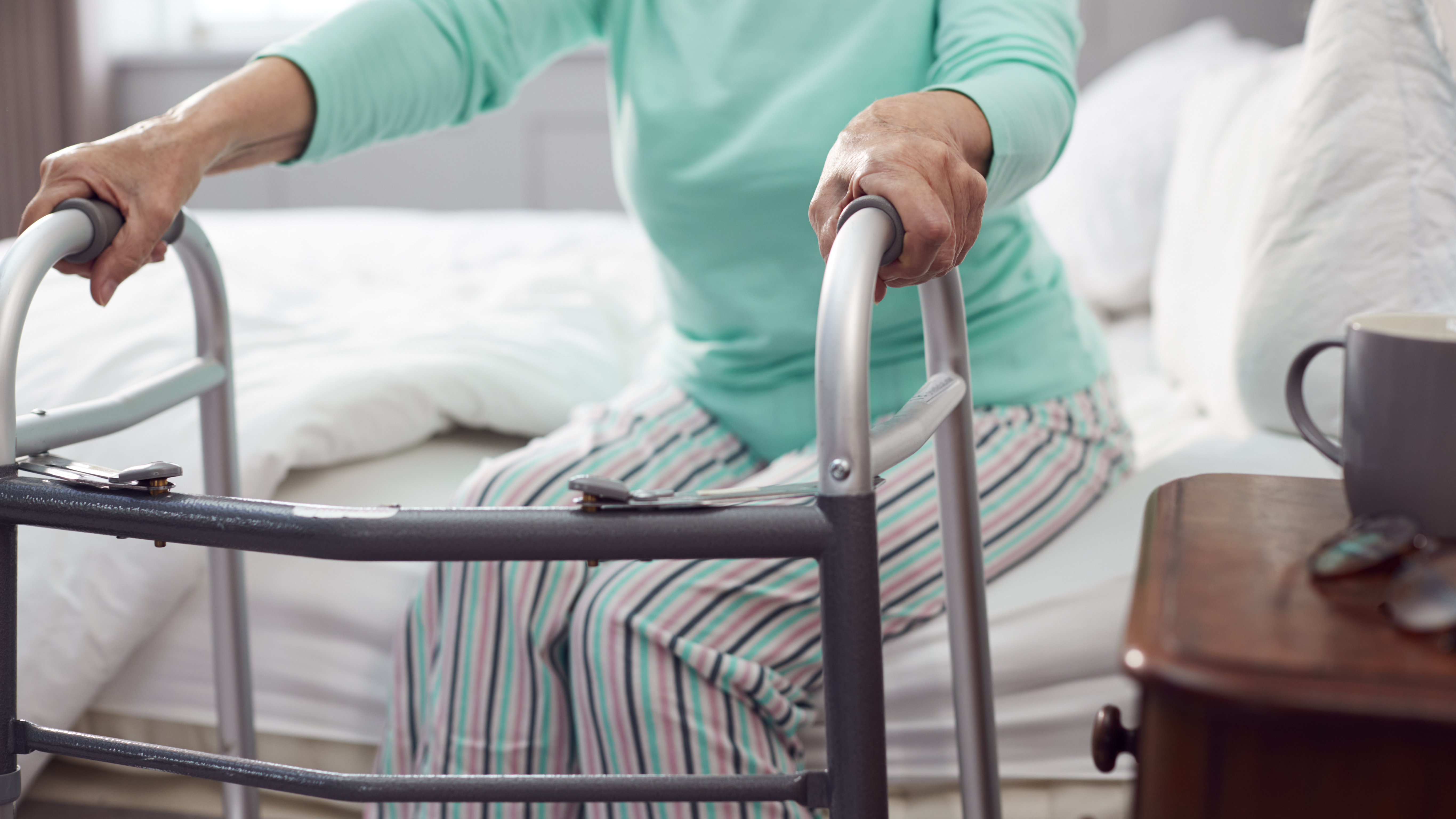 close up of senior woman at home using walking fra 90276e6b22c28cde1e1d