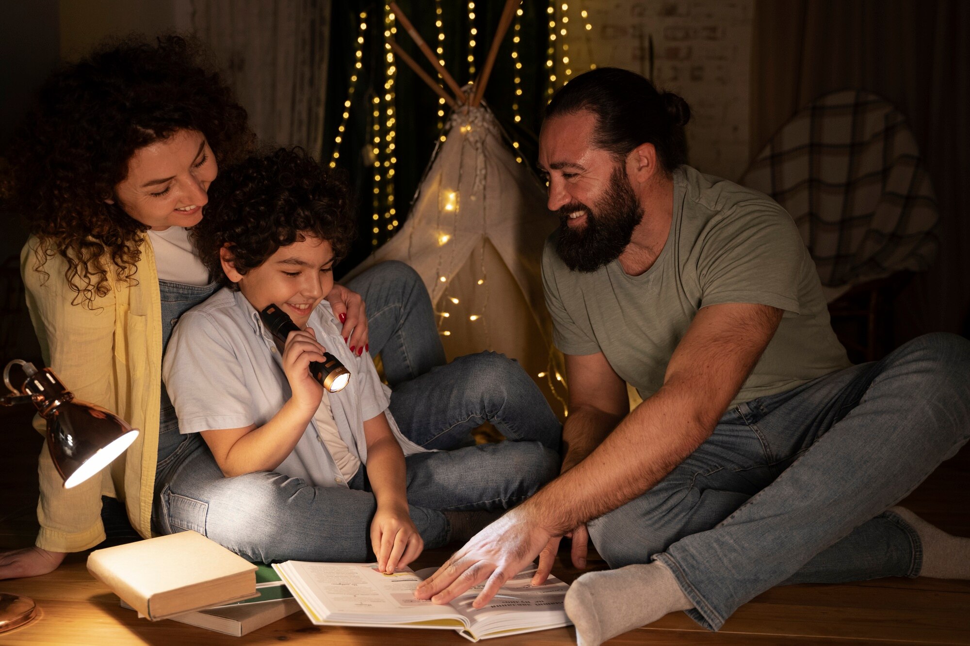 close up on child reading with his parents a395903c58171221b6b0