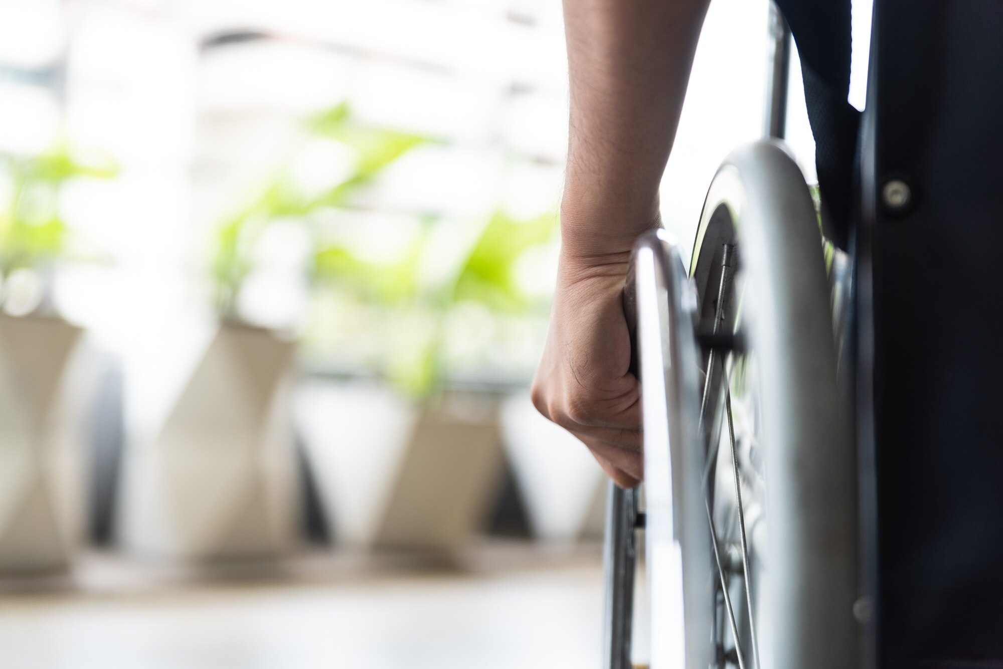 closeup disabled man hand on wheel of wheelchair ea5fb80d843f403f4258