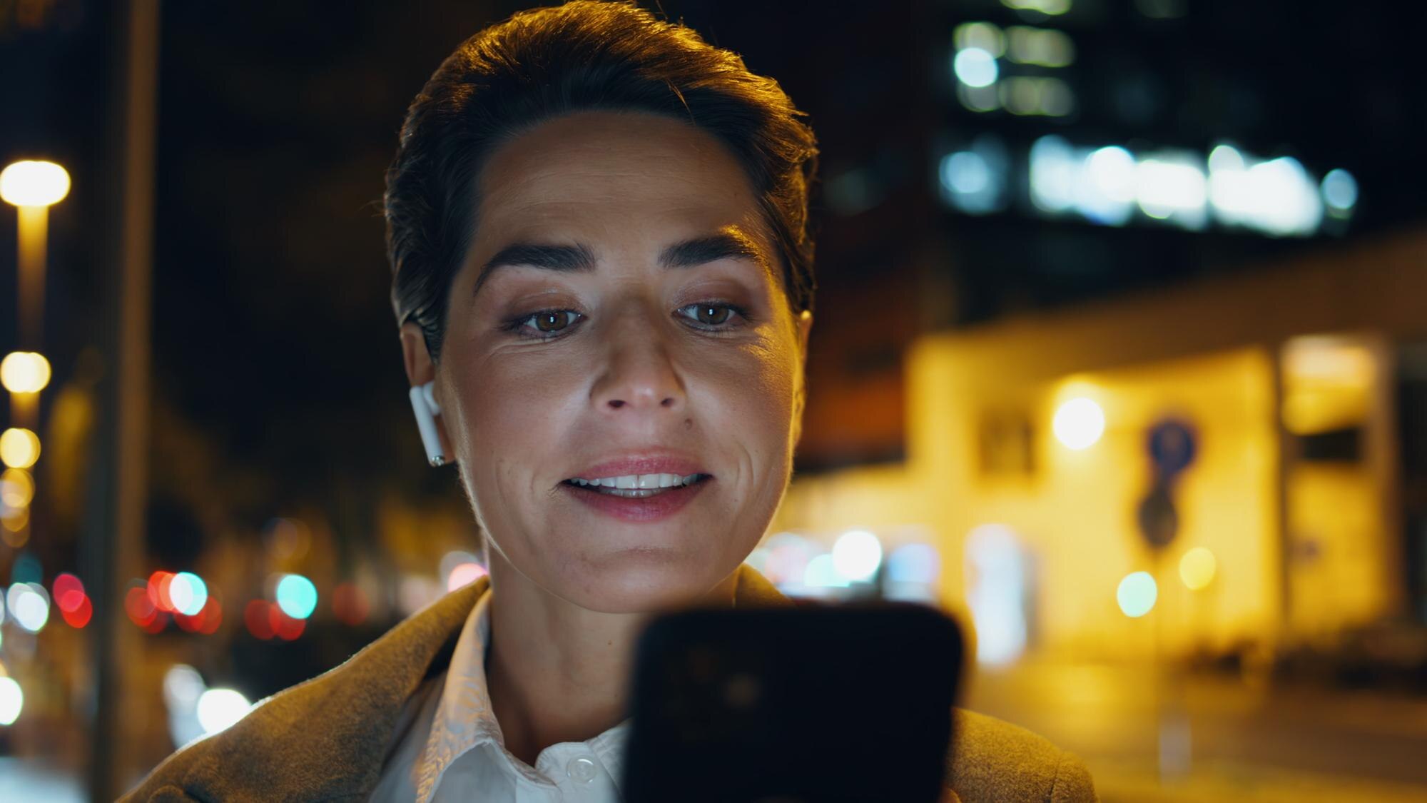 closeup happy woman surf smartphone in night city 4314c007440ca002932c