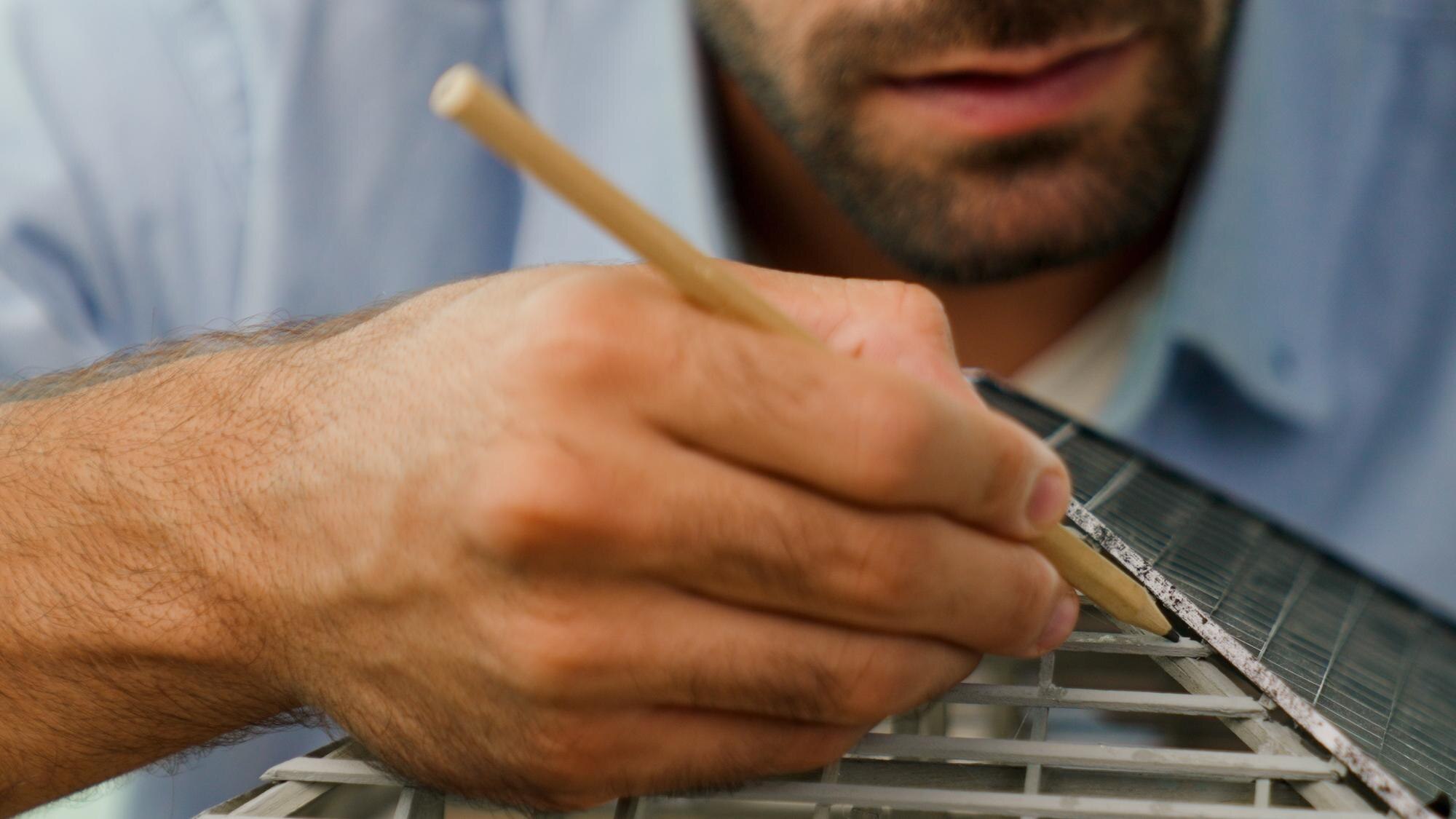 How to choose cut-to-size plastics for damp and cold‑weather jobs 1 closeup image of engineer using pencil measuring m 7f3281bbc4b44a247a09