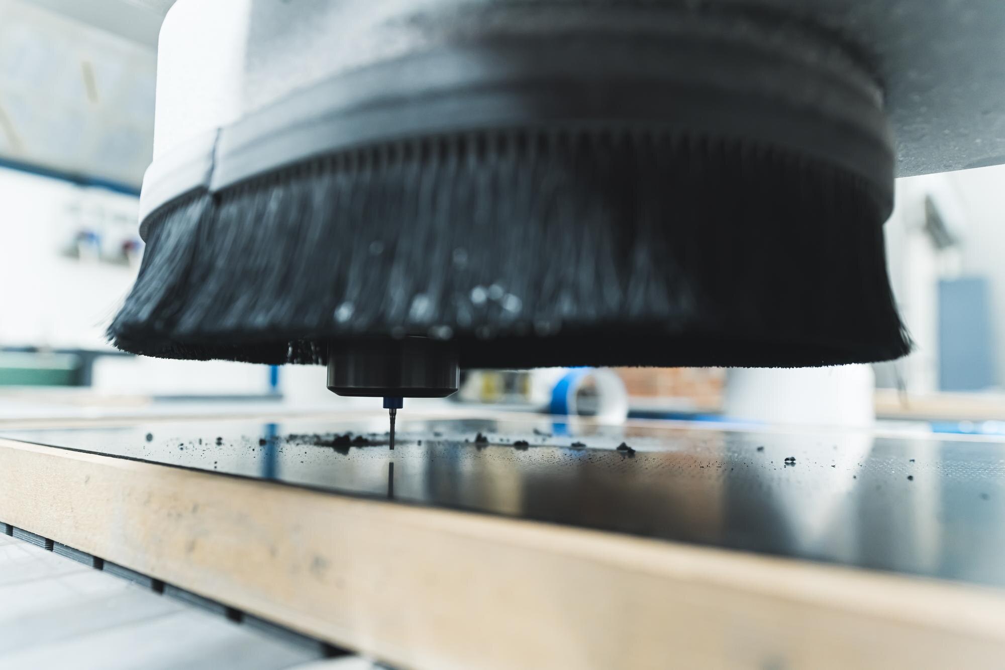 CNC laser vs water jet cutting for plastics: which method suits your project? 1 closeup shot of a milling machine cutting the fibe aa7ae75b19441e2aeb51