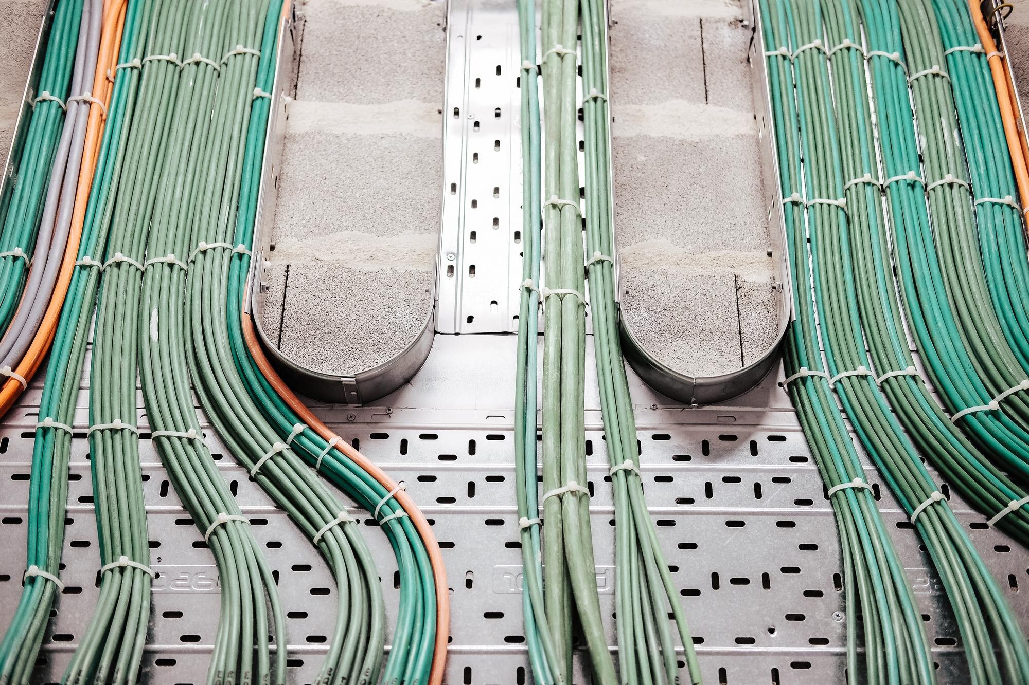 closeup shot of green wiring on a silver backgroun 686da472367be71a71b8