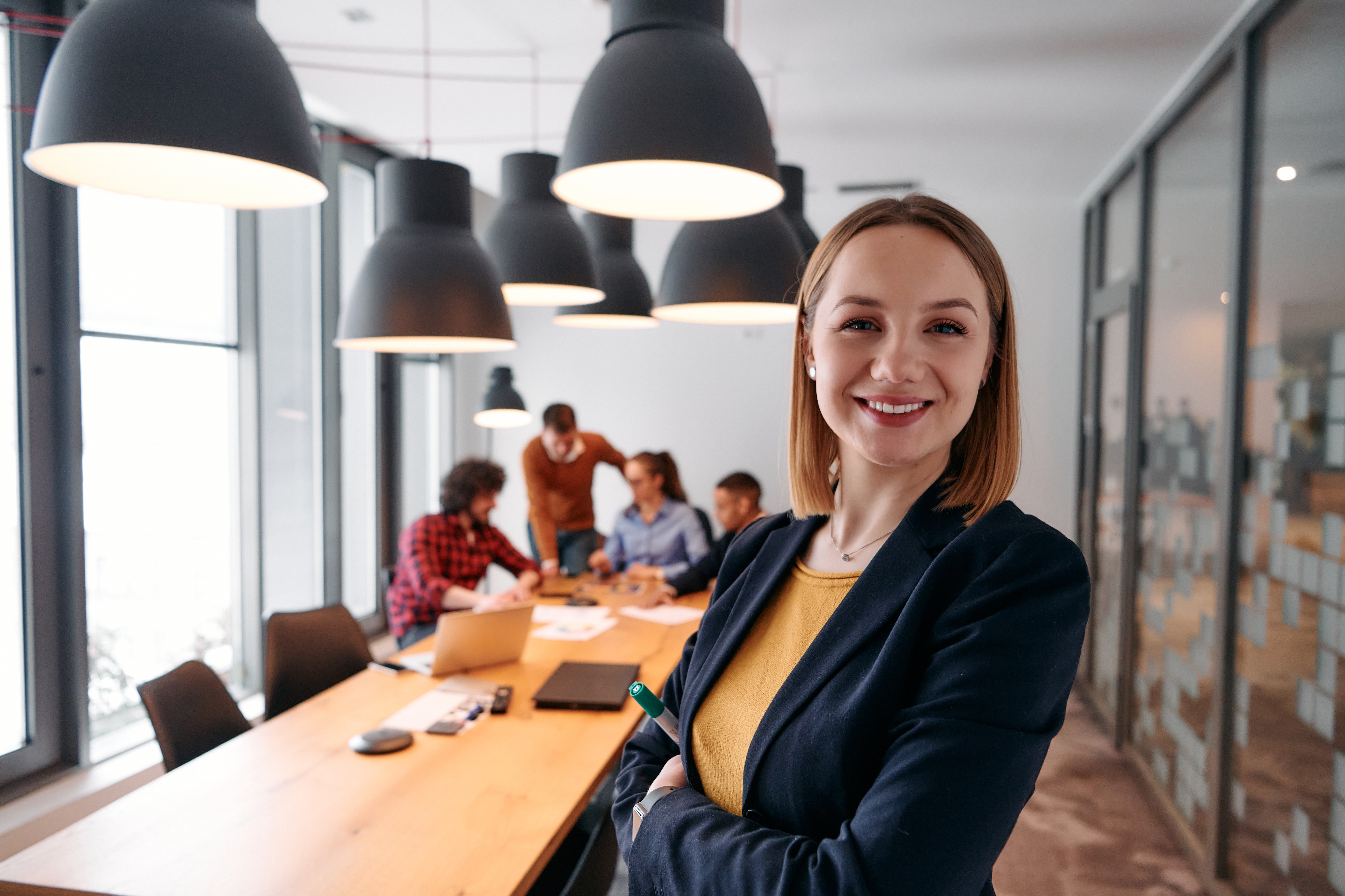 confident blonde businesswoman leading team in mod f82594e0ef867a39b88b