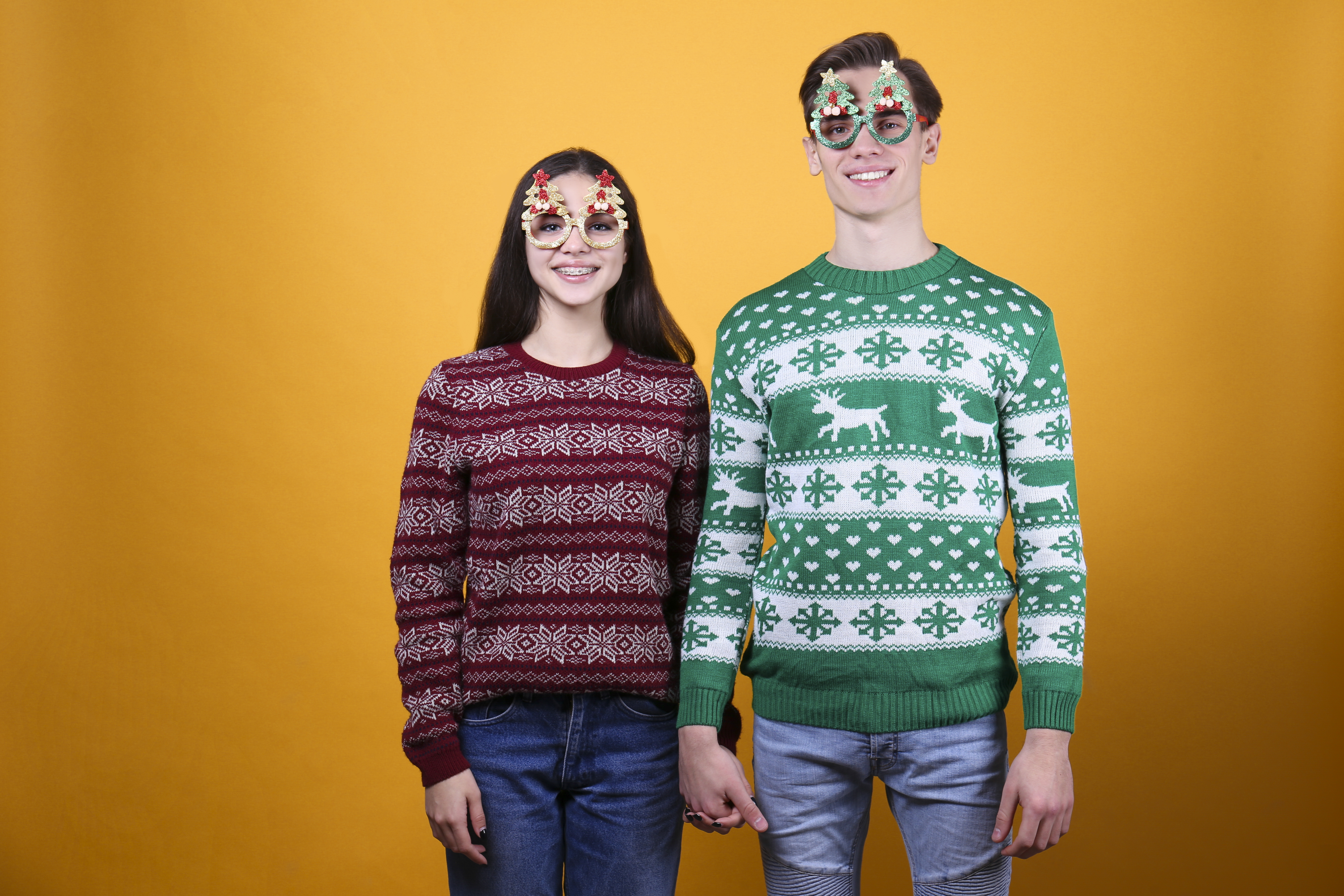 couple of young people wearing ugly christmas swea b134eadb4f3cadc4f106