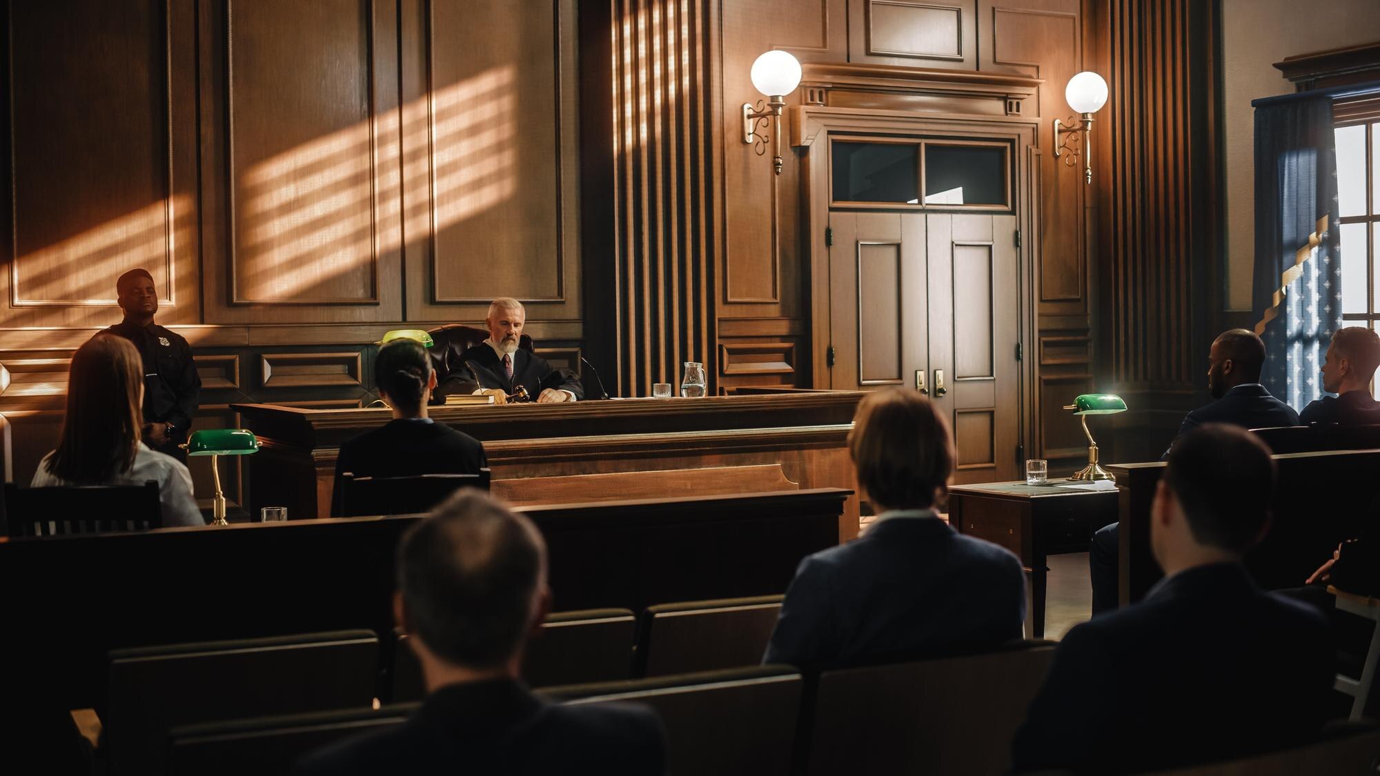 Courtroom scene featuring an impartial judge presiding over a trial, with attorneys and audience members present, emphasizing the importance of legal representation in criminal defense.