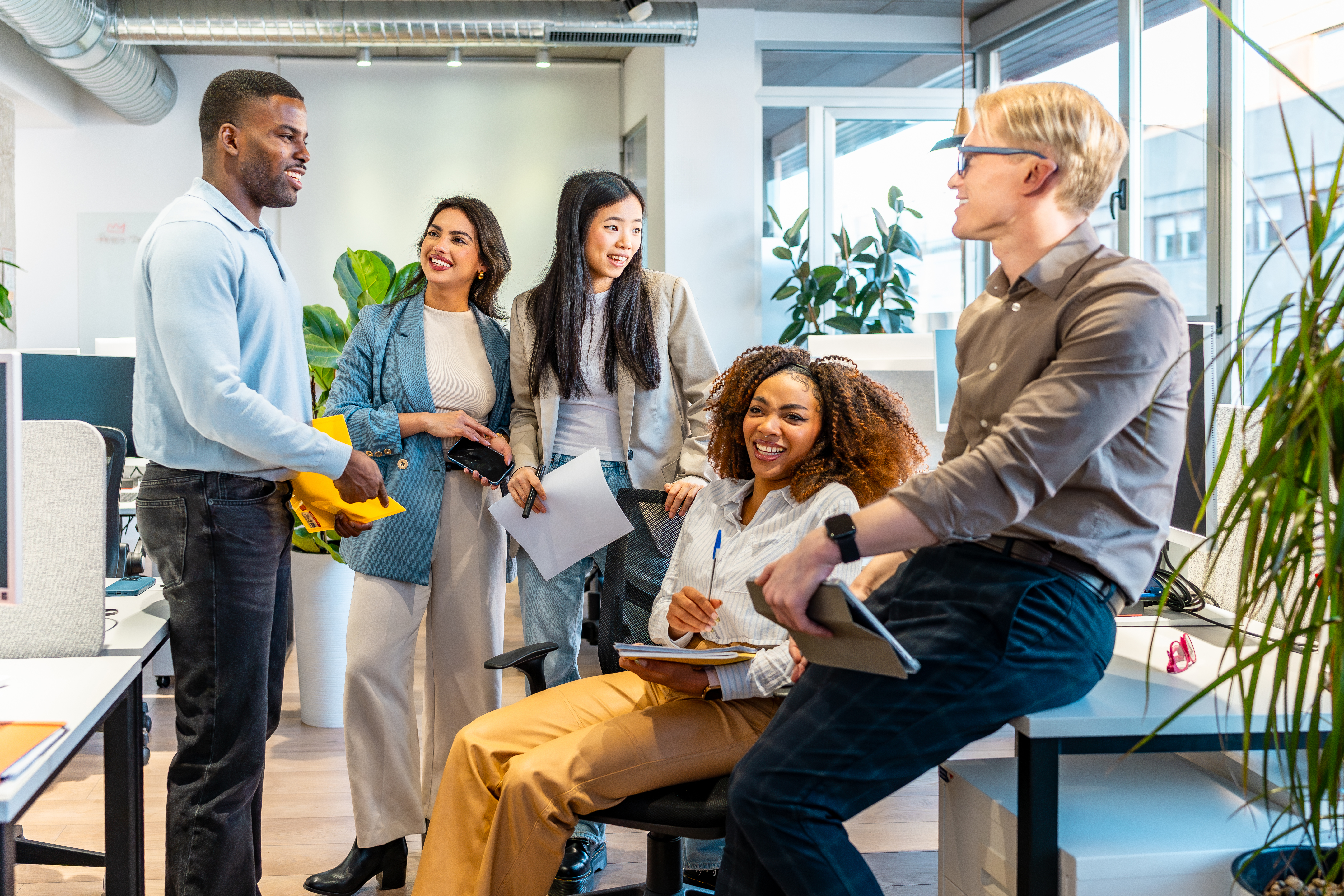 coworkers exchanging ideas in modern office enviro ab413b1dc78ba5eb1345