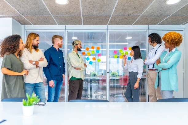 coworkers using colorful adhesive notes with ideas b6837745851880fdf39a