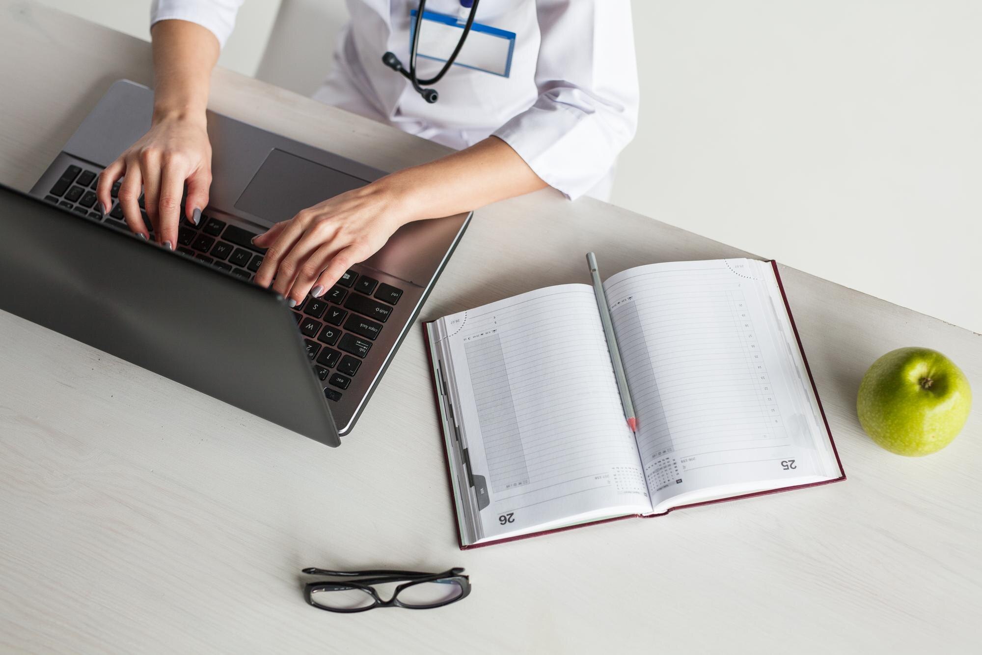 Oet Speaking Tips: Patient‑Centred Strategies To Boost Your Score With Confidence 4 crop doctor using laptop at desktop 789c51f0fee94fa9aa9f