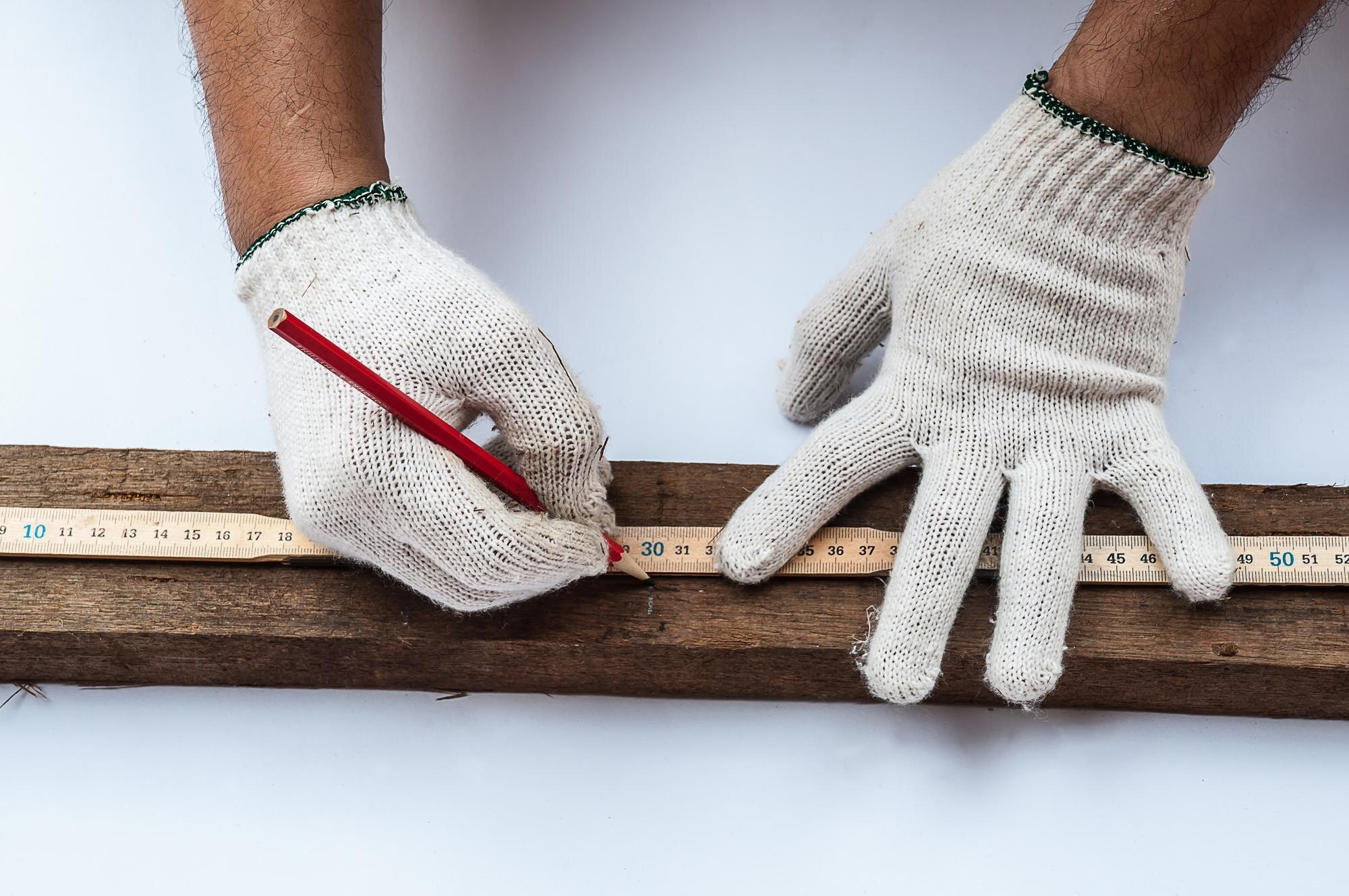 Affordable, winter‑ready plastic solutions for Aussie DIY & trade projects 1 cropped hands of carpenter measuring wood on table 4b8cdc590917419238c1