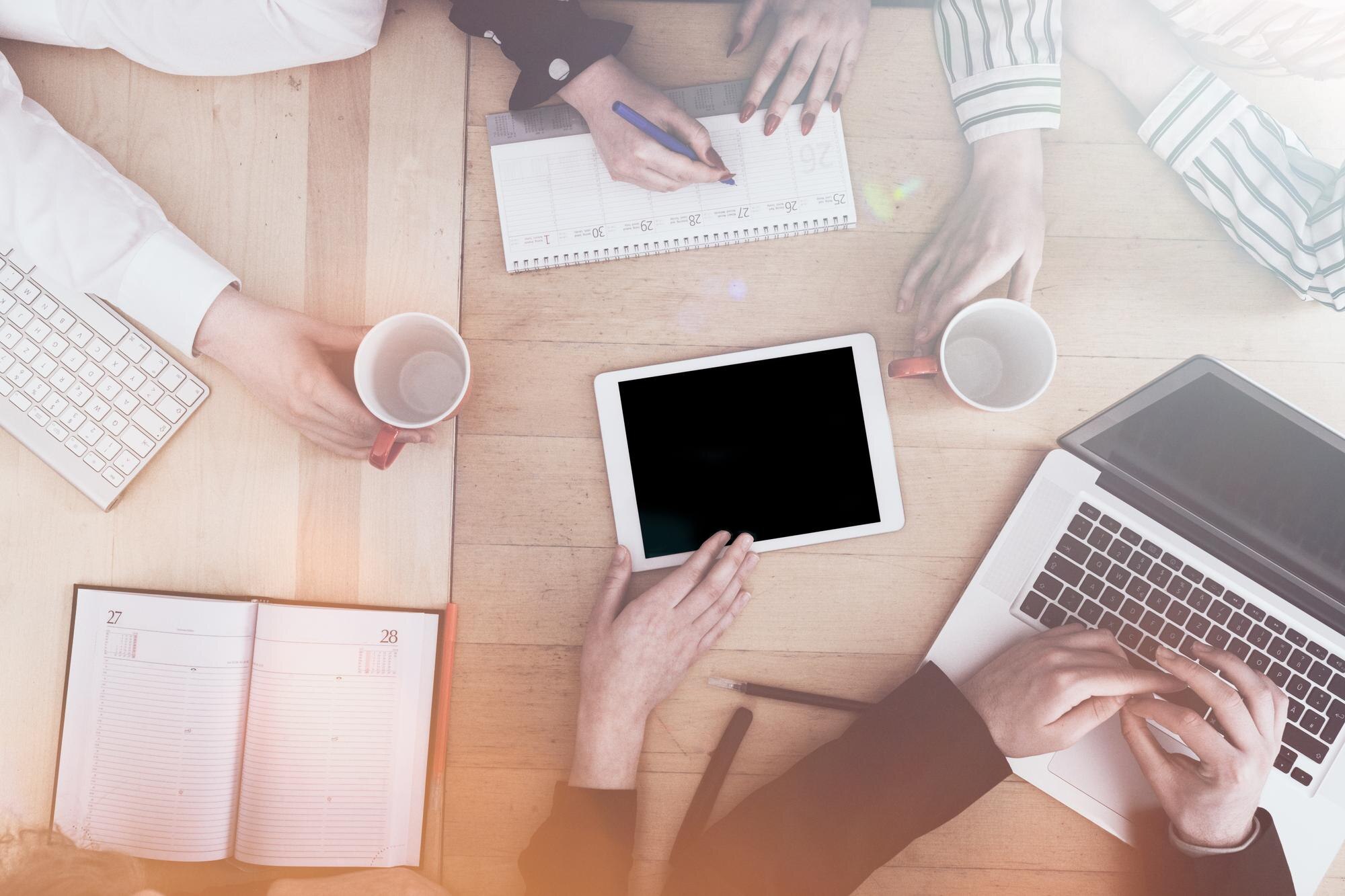 cropped hands on business people working on table c8016d30898570fe304f