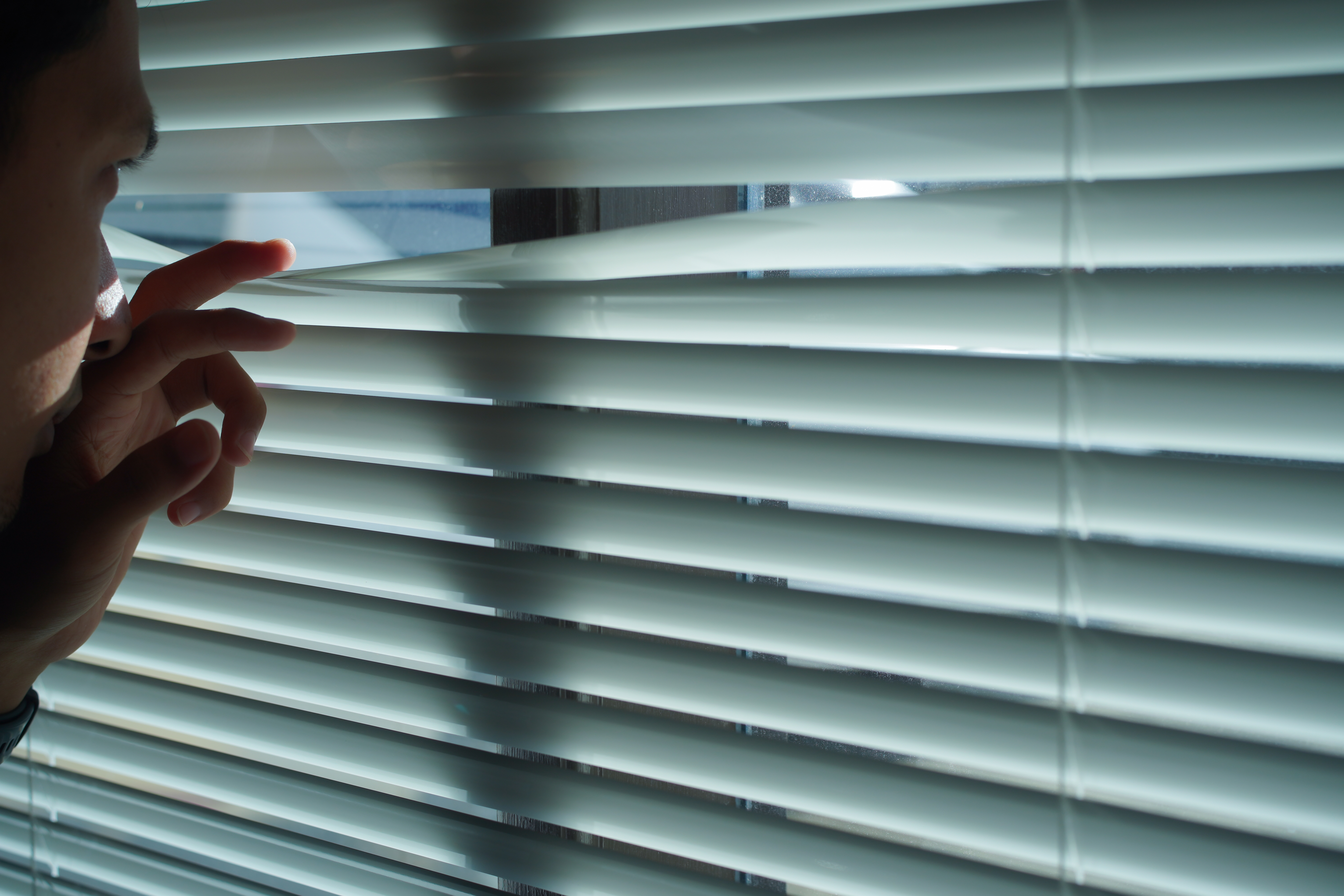 Why Local Plastic Fabrication Pays Off: Faster, Safer, and Built to Aussie Standards 1 curious man looking through venetian blind 064c194d899db8034057