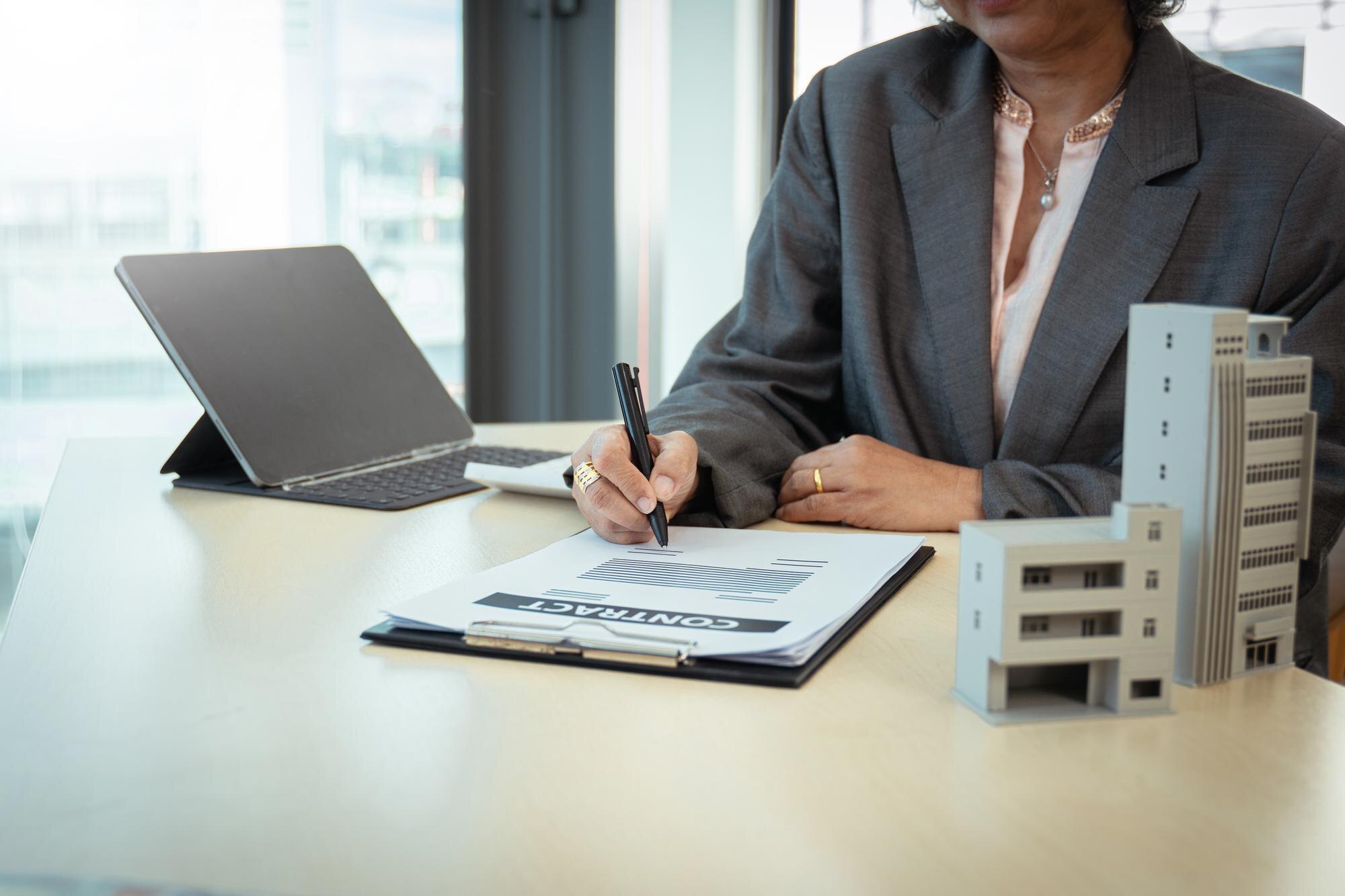 Signing Commercial Loan Paperwork Business client signing commercial mortgage agreement paperwork
