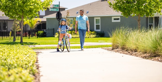 Featured image: Dad guiding his son first bike ride pedaling toget-eaeb1a8493bb96c30d2c