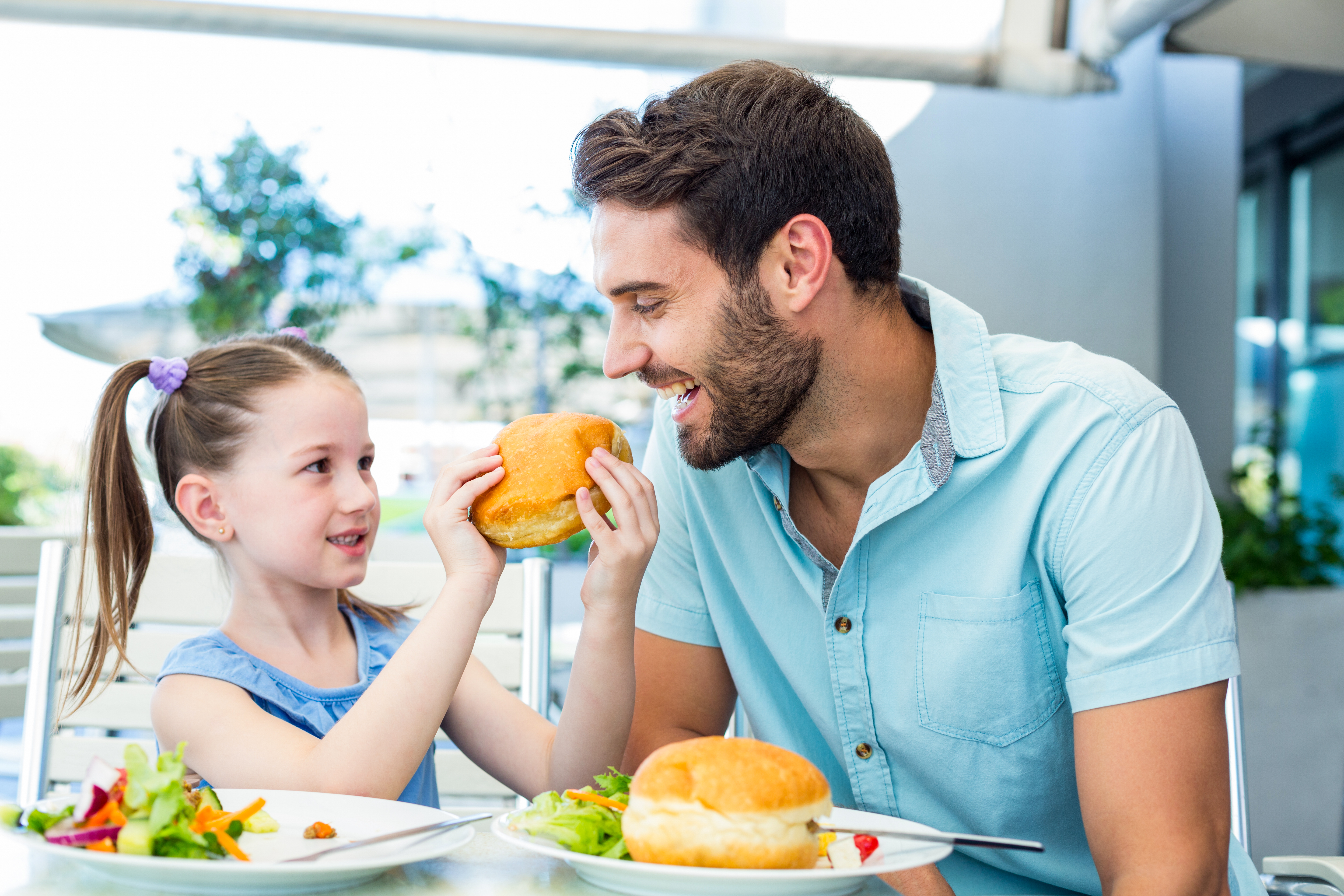 Family Nights, Done Right: Quick, Wholesome Meals at Jubilee Juice & Grill! 1 daughter and father eating at the restaurant 83661ad64e0943a54c03