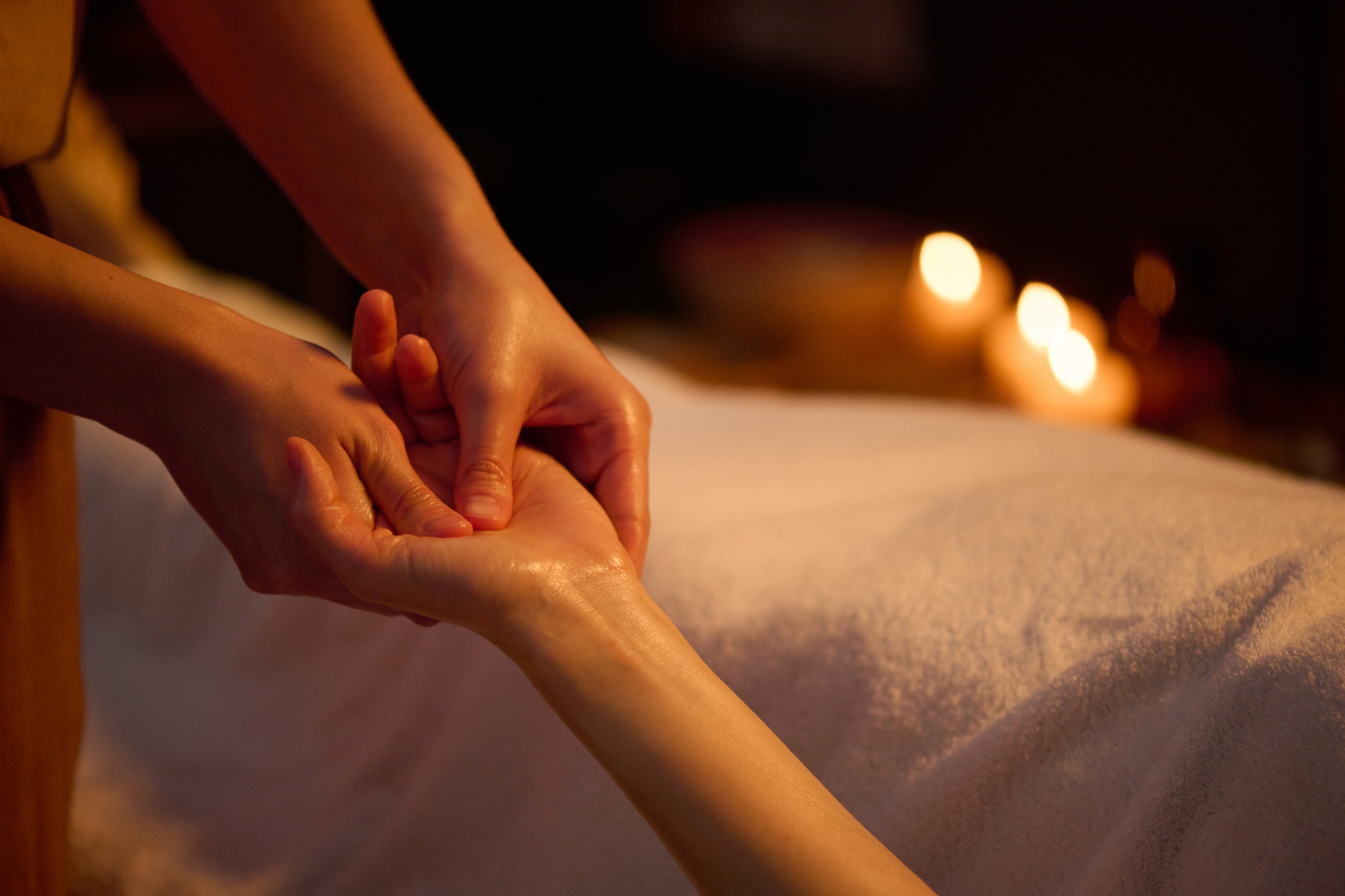 Therapist performing relaxing hand massage treatment at a spa