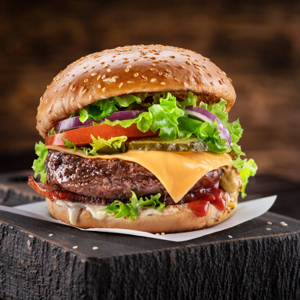 delicious hamburger on a wooden table with a dark f5b9e8321fe4788fc427