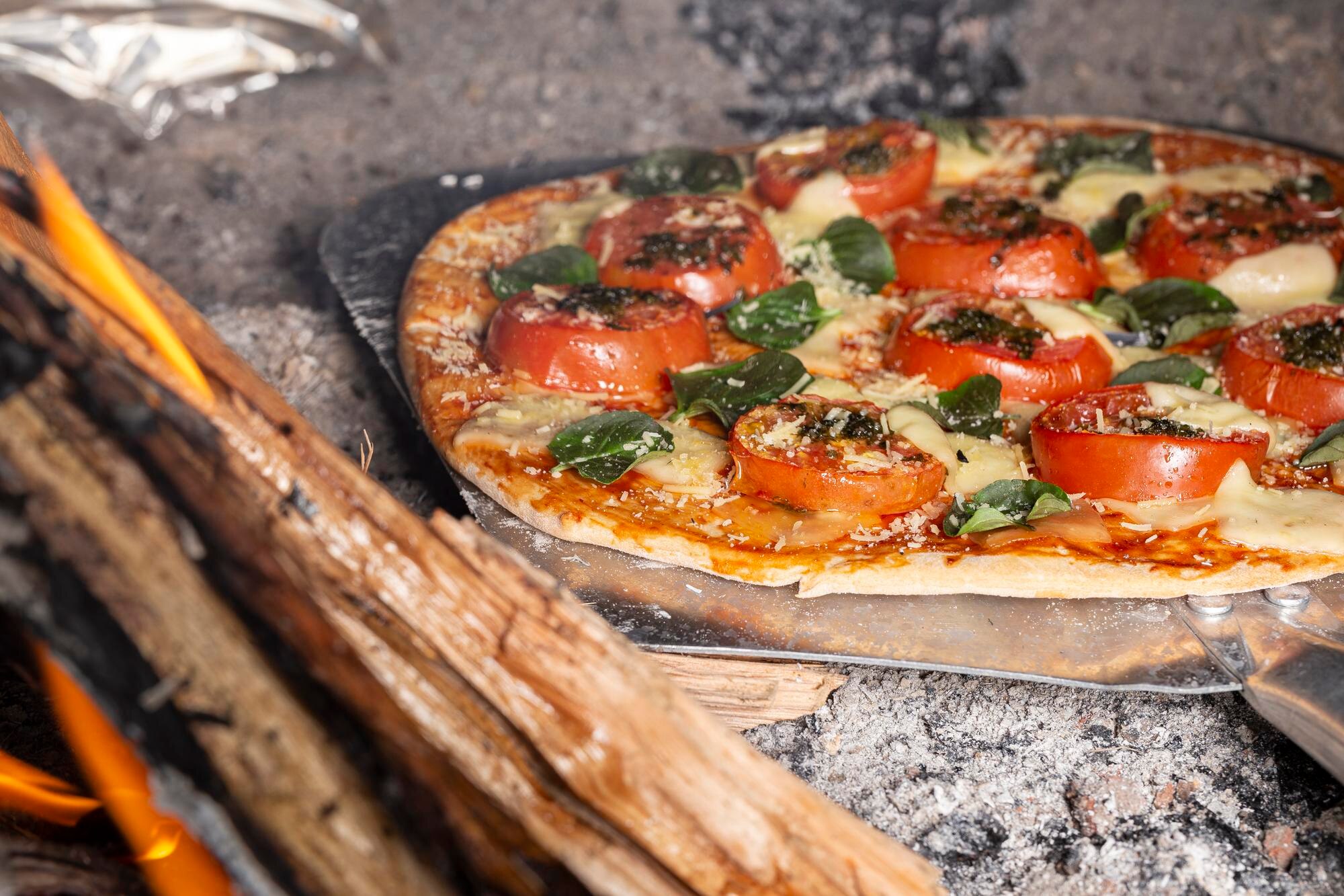 Thin crust baked pizza, tomato spinach feta