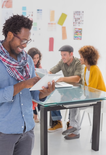 Reimagine Your Brand: The Power of a Strategic Redesign 4 designer standing and using his tablet 17b9e202e397f33cfaa1