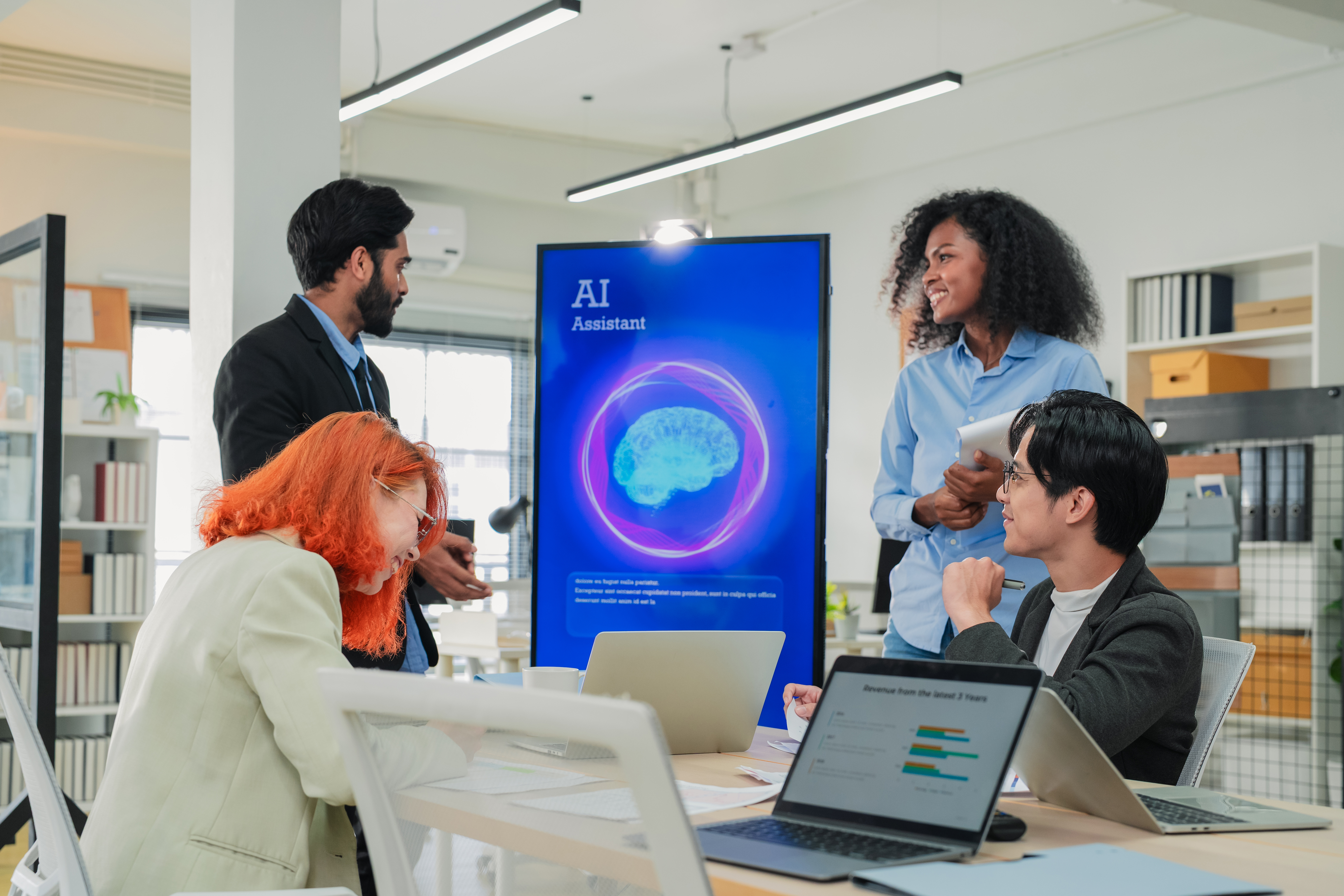 Diverse business professionals collaborating in an office setting, discussing AI tools for local SEO, with a screen displaying "AI Assistant" and a brain graphic in the background.