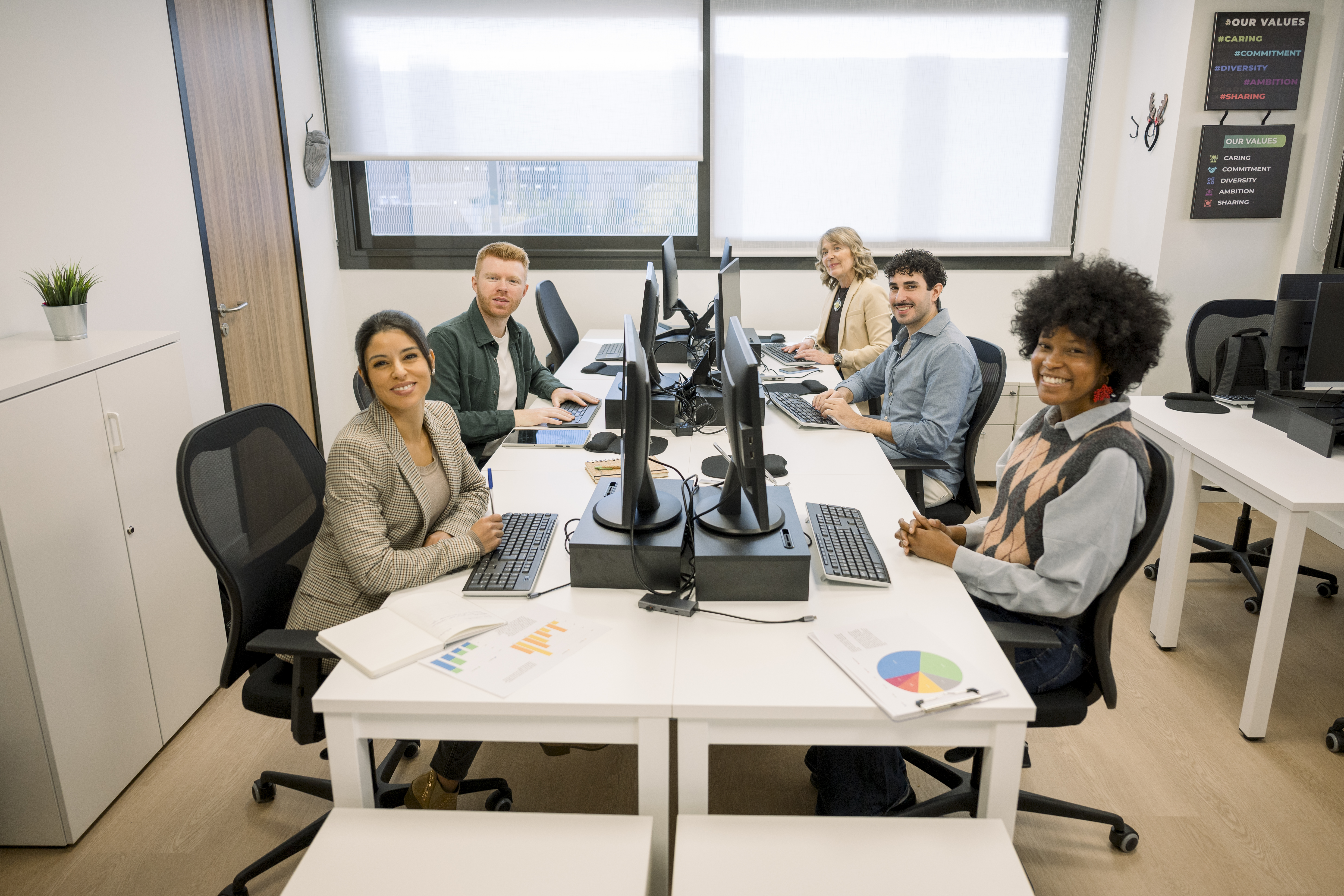 diverse business team smiling at shared office wor e4a5a7dd319c81261b43