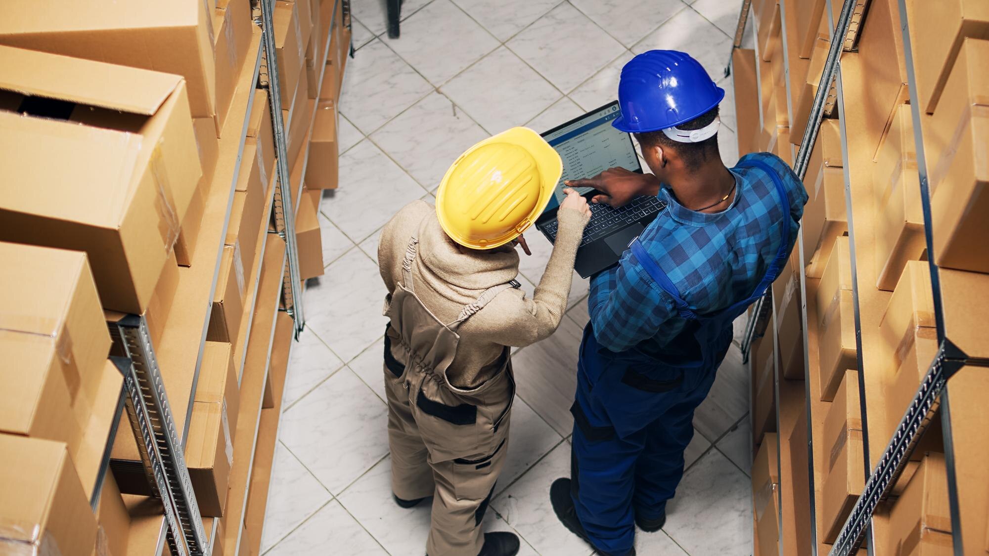 diverse employees analyzing inventory list on lapt 2c4a1b91306bec57bfdc