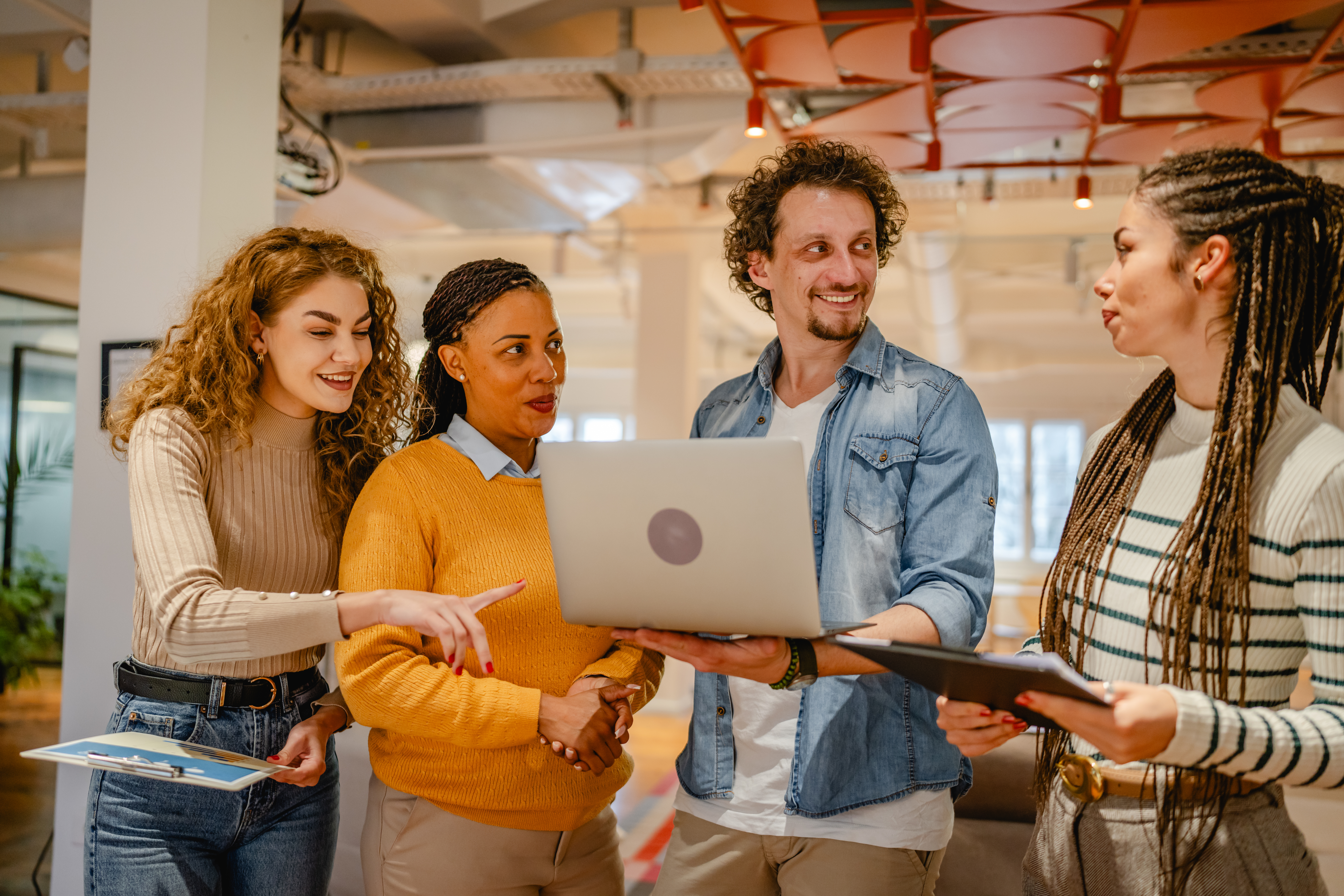 diverse group businesspeople stand and use laptop c6383f494157d4a7483a