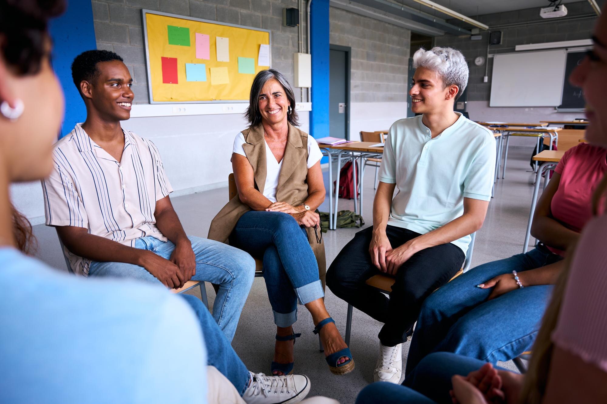 diverse group of high school students sitting on c 03f031f00b0515ba634b