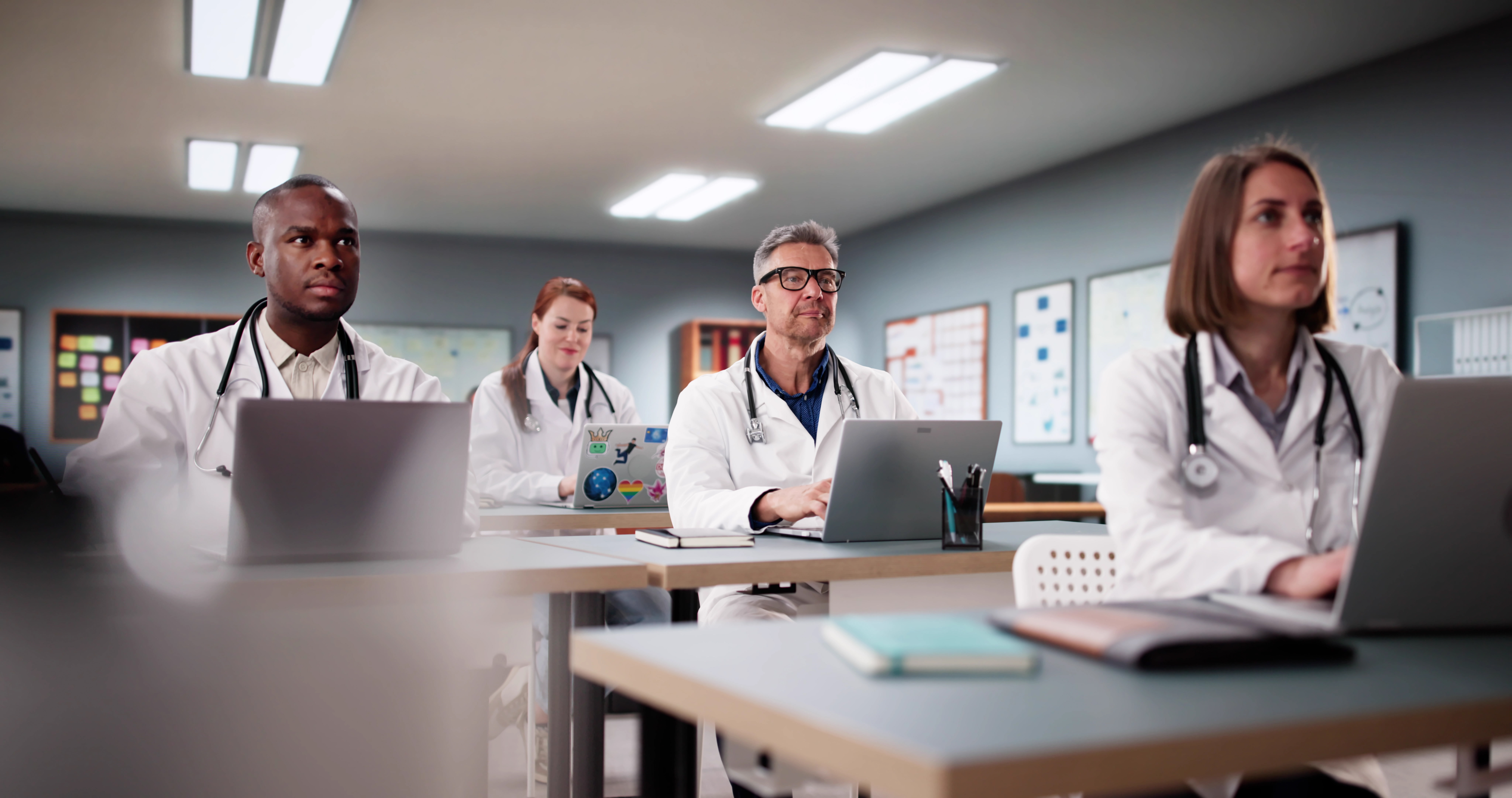 Unlocking Success: The Power Of Expert-Led Oet Preparation For International Medical Graduates 2 image of a group of medical workers on their laptops to illustrate OET preparation courses by Accordemy® - #The best OET preparation course