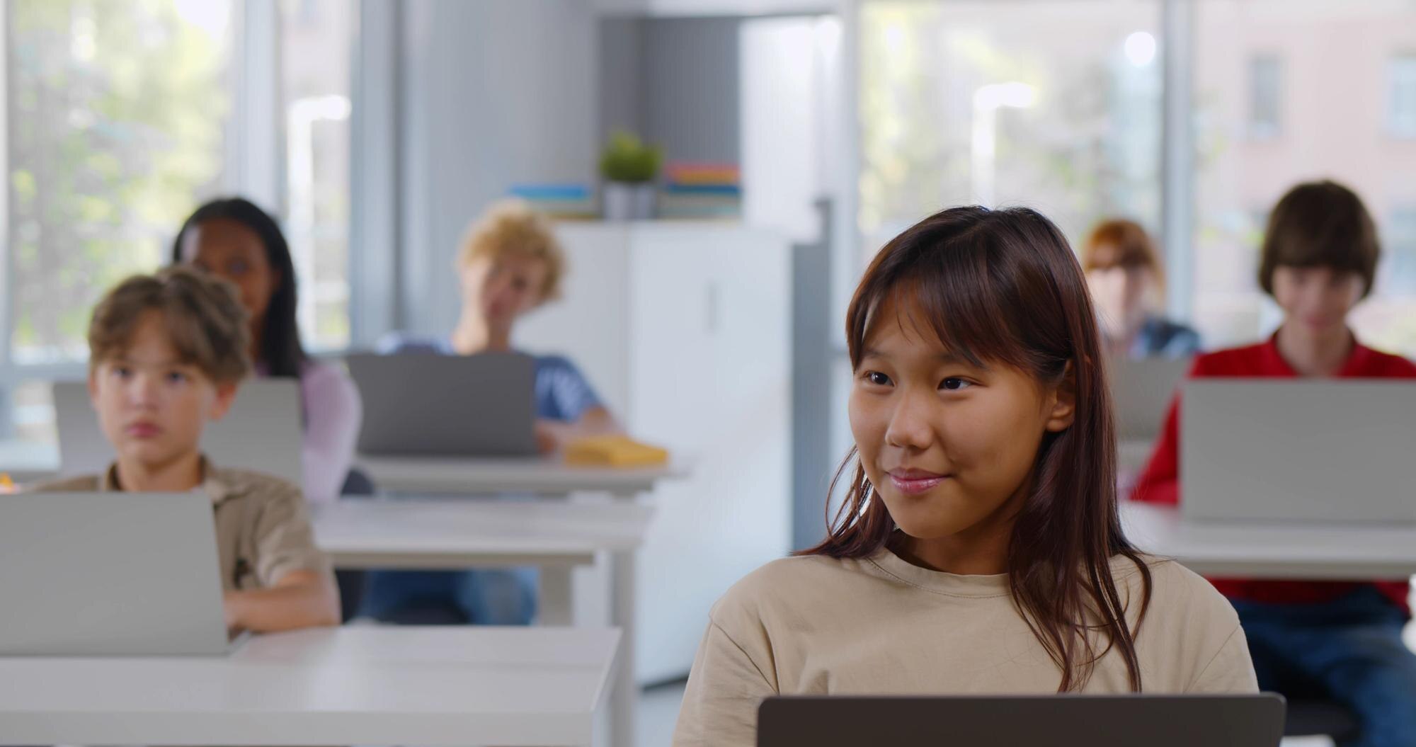 Diverse Group Of Teen Children Using Laptop Sittin 0bb615976cf5fb3c585a