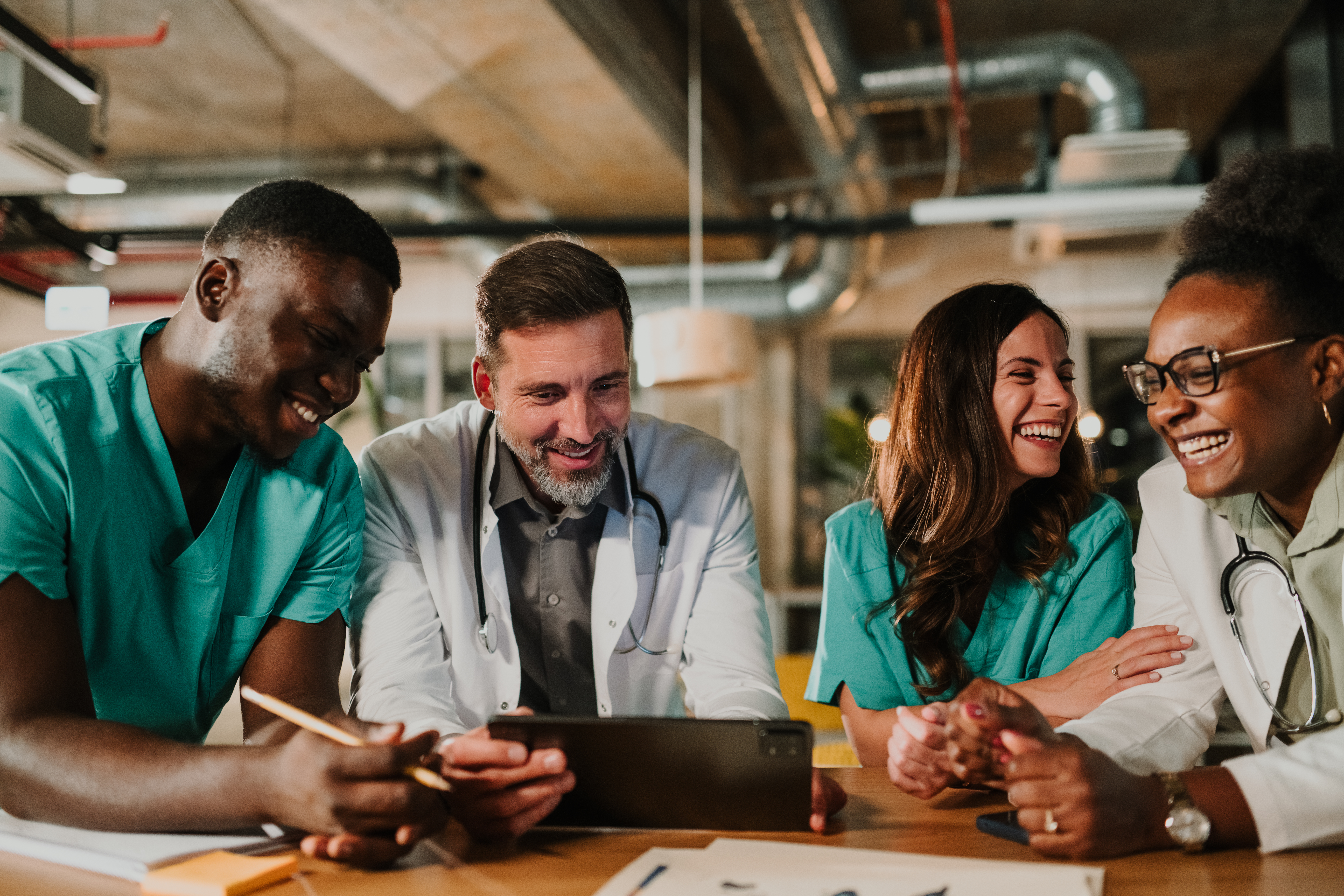 diverse medical team collaborating laughing lookin ce251d44e0ee6a4b4d32