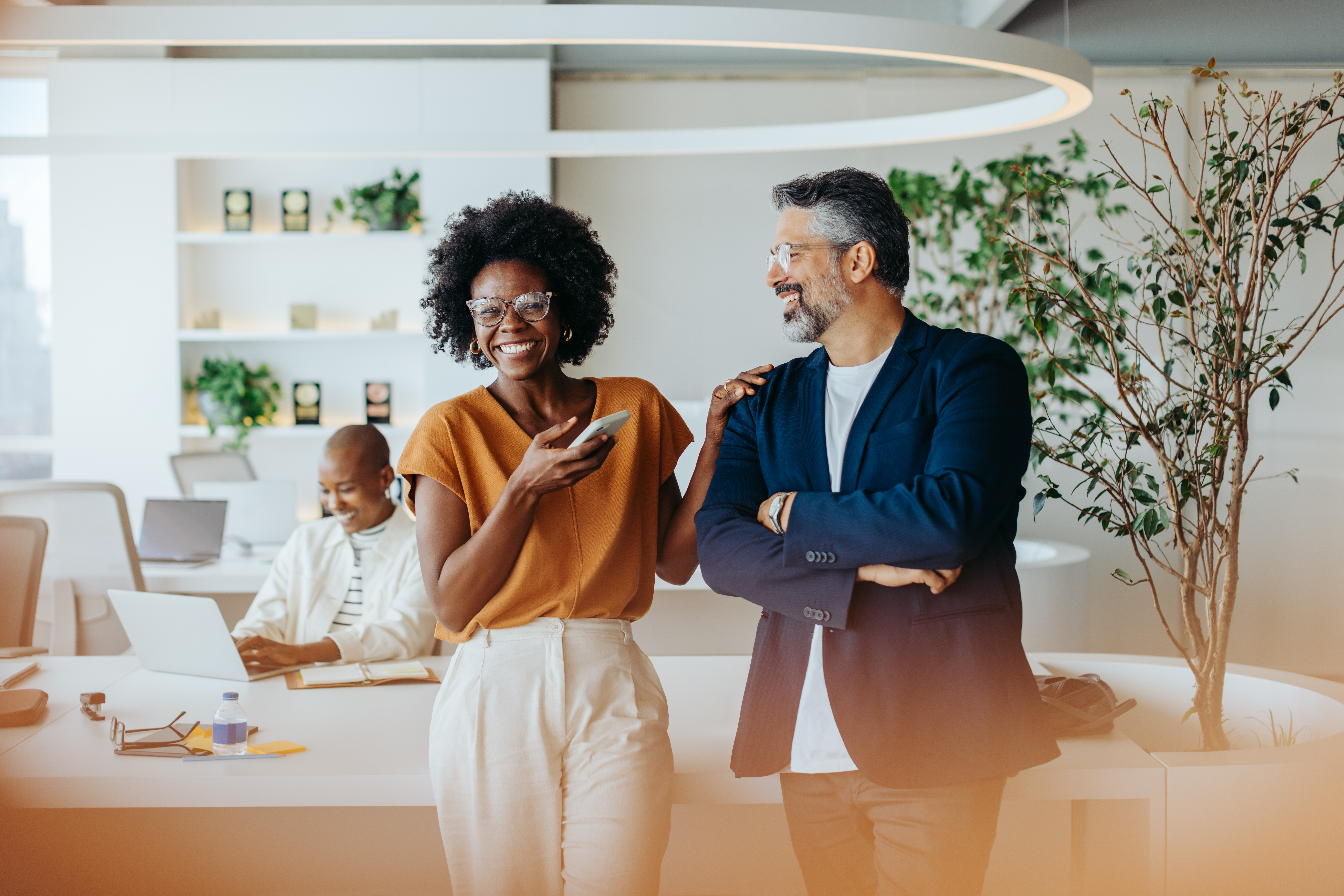 woman and man laughing and talking in an office