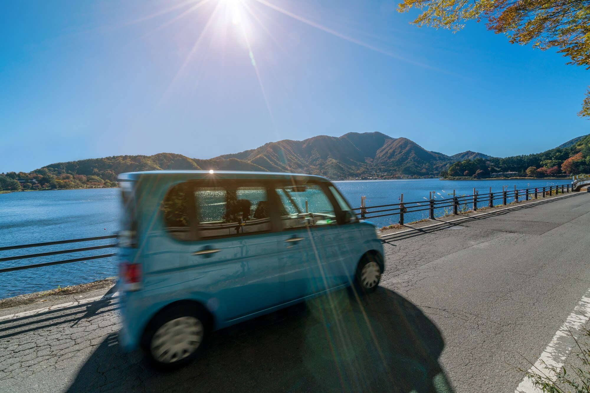 eco car driving on road near lake and mountain 268588aadc0641fc8fe0 BTOURS