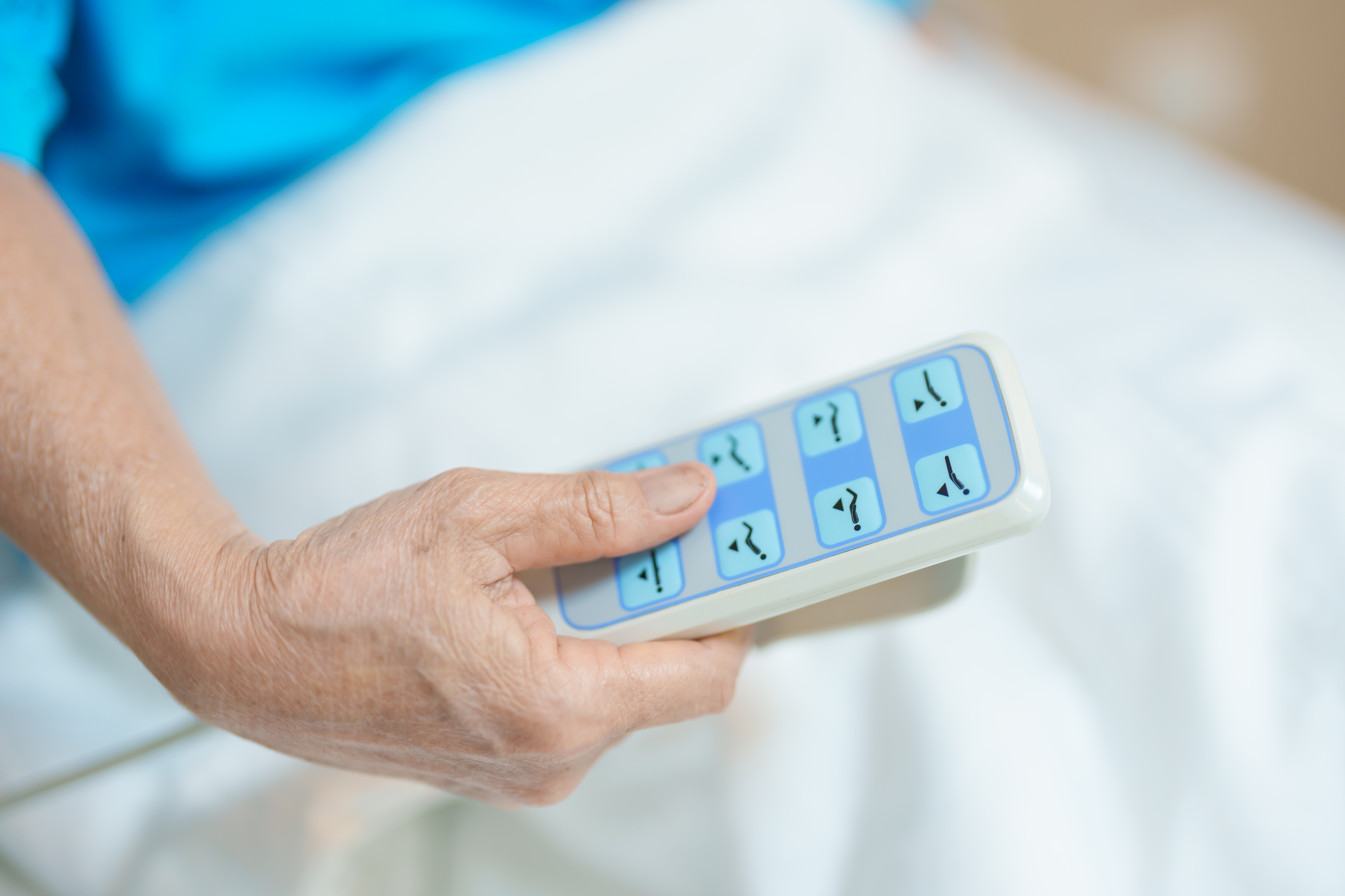 elderly asian woman patient hand using remote cont 2d106808d5ff6a5ac3d2